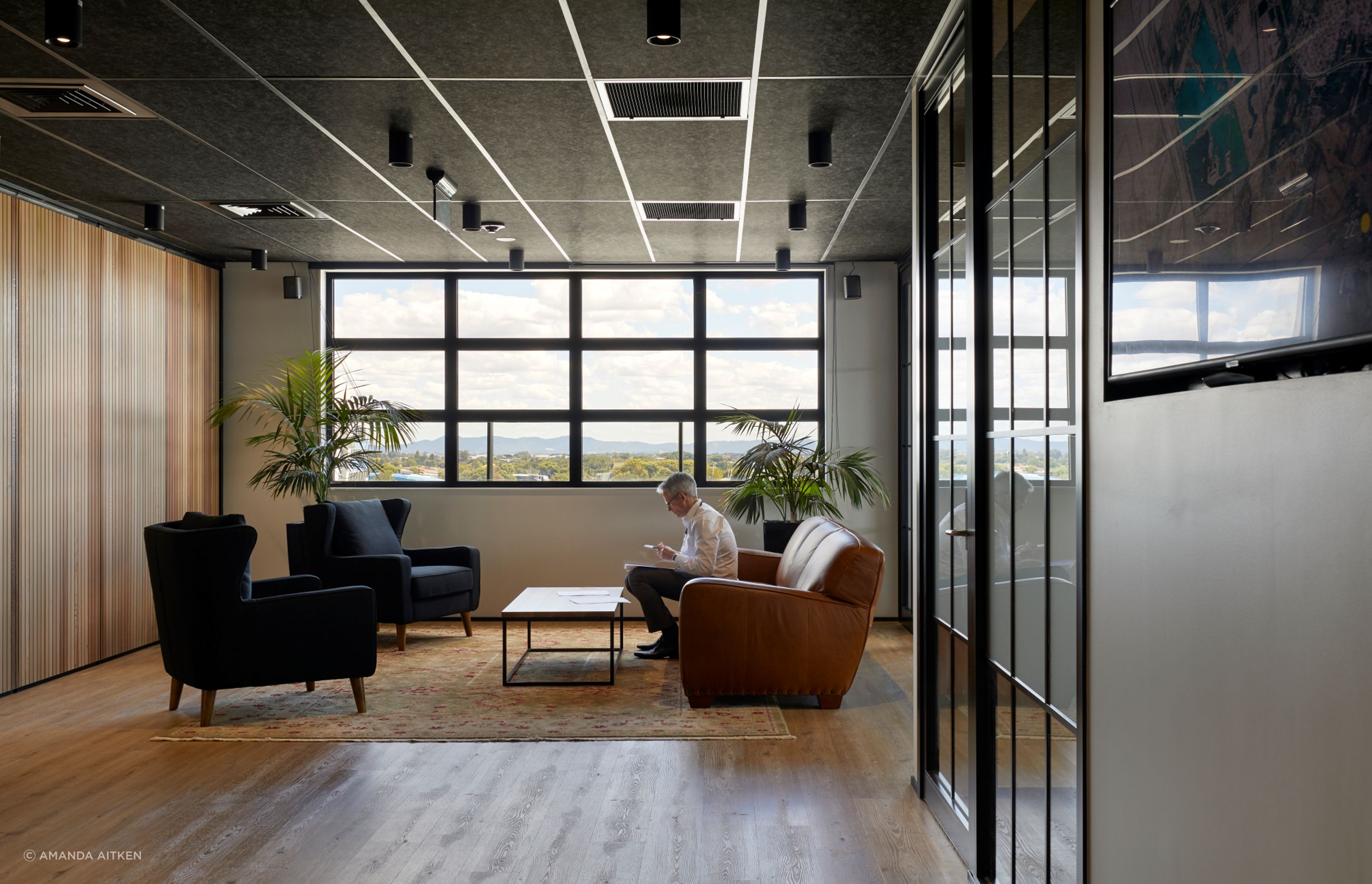 Timber elements amd plush rugs were introduced to soften the hard surfaces.