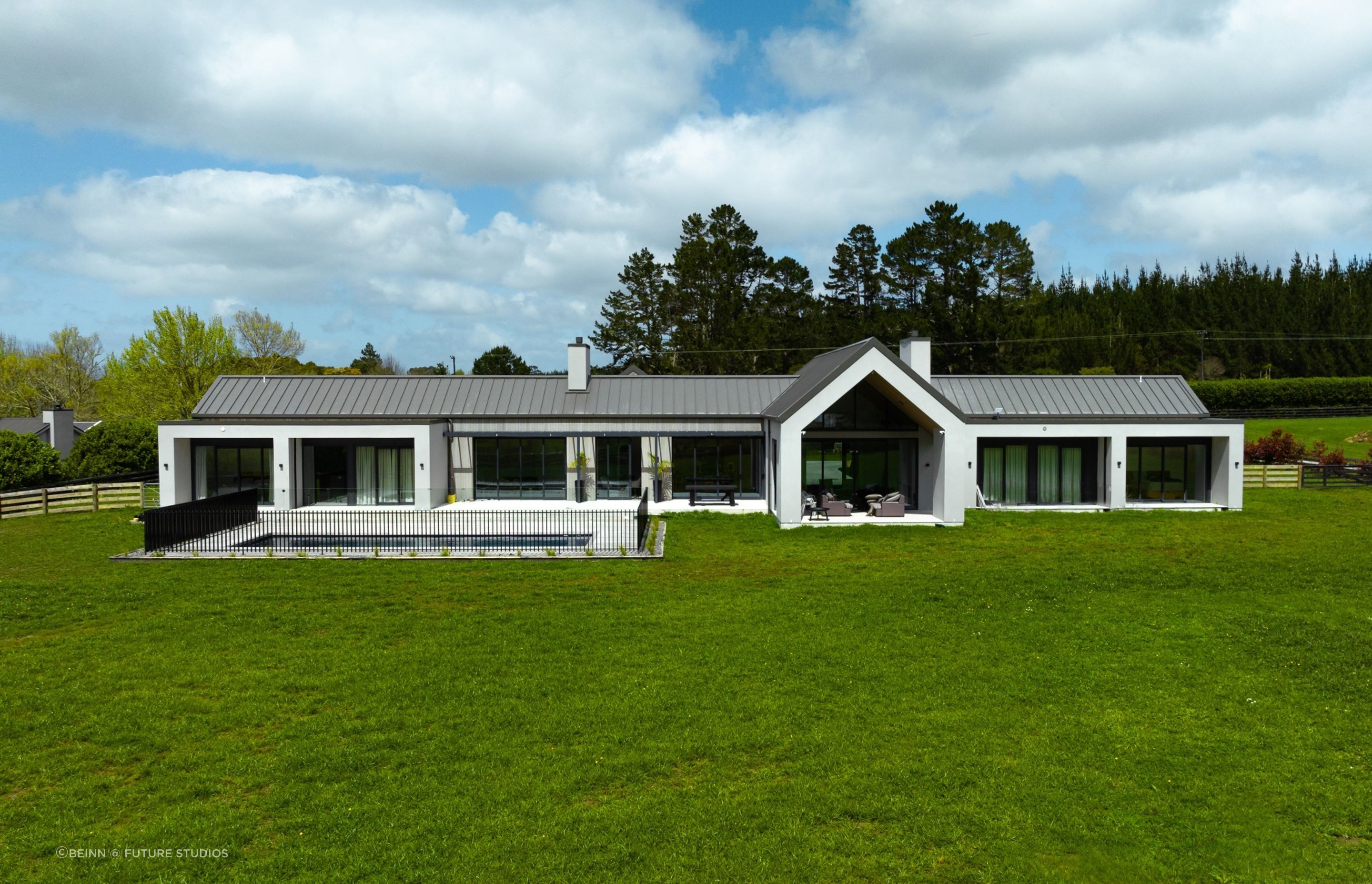 From the rear, the form of the home reads as an intersection of simple gable forms.