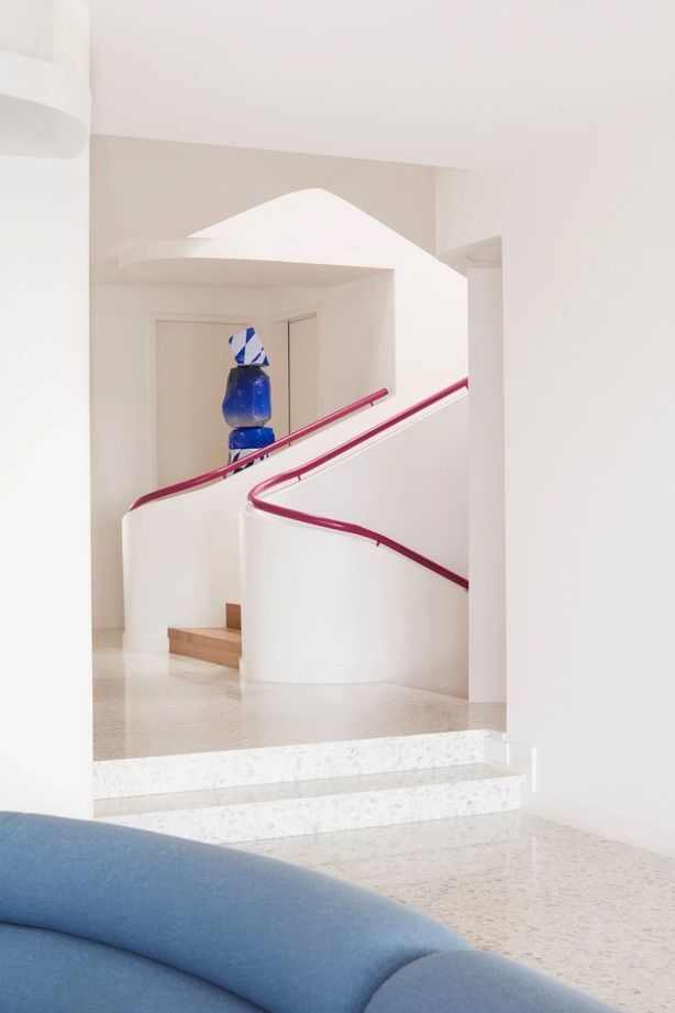 The magenta handrail can be seen on all three levels of the home.