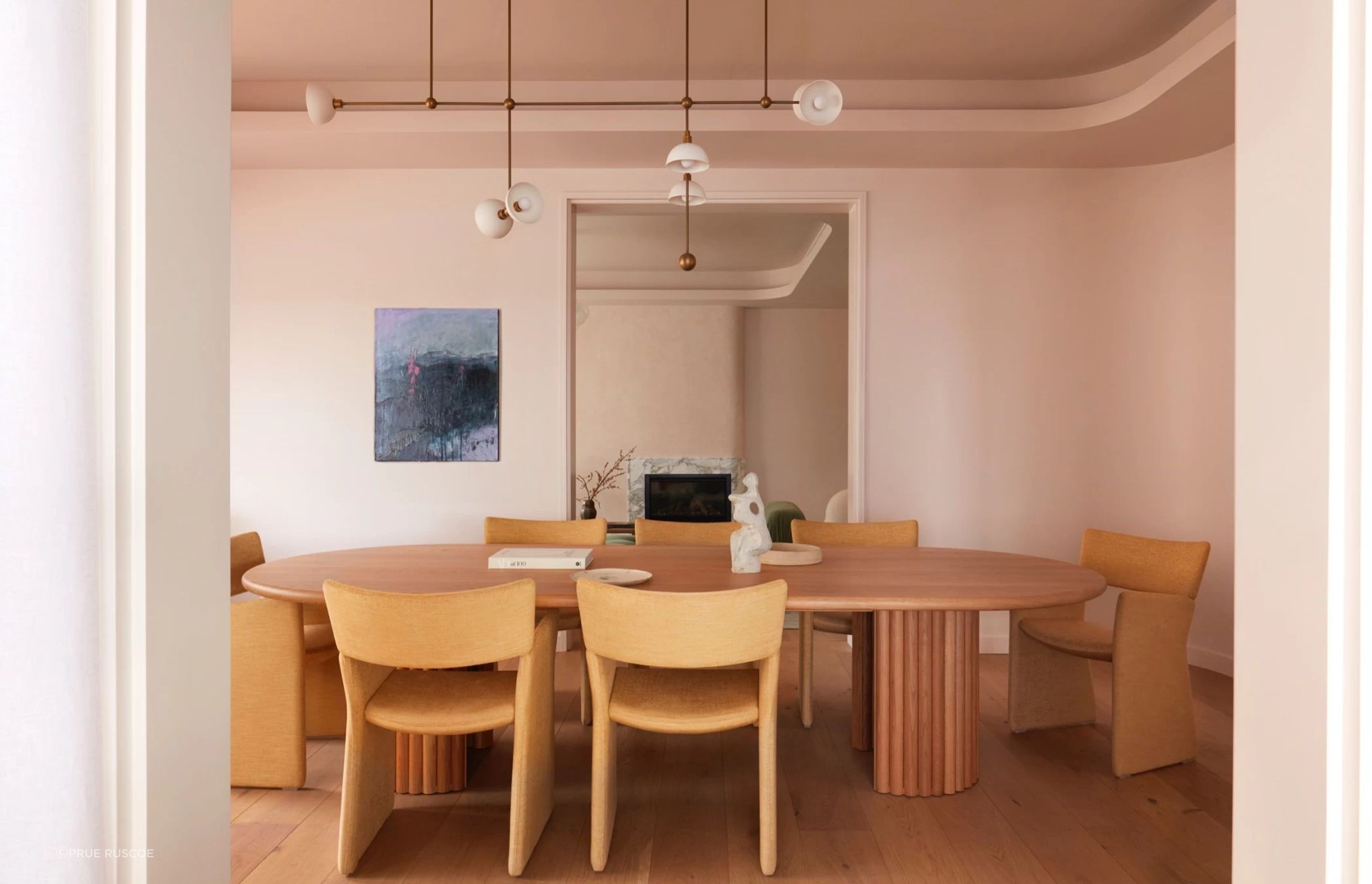 The pastel pink wraps around the curved walls of the formal dining room.