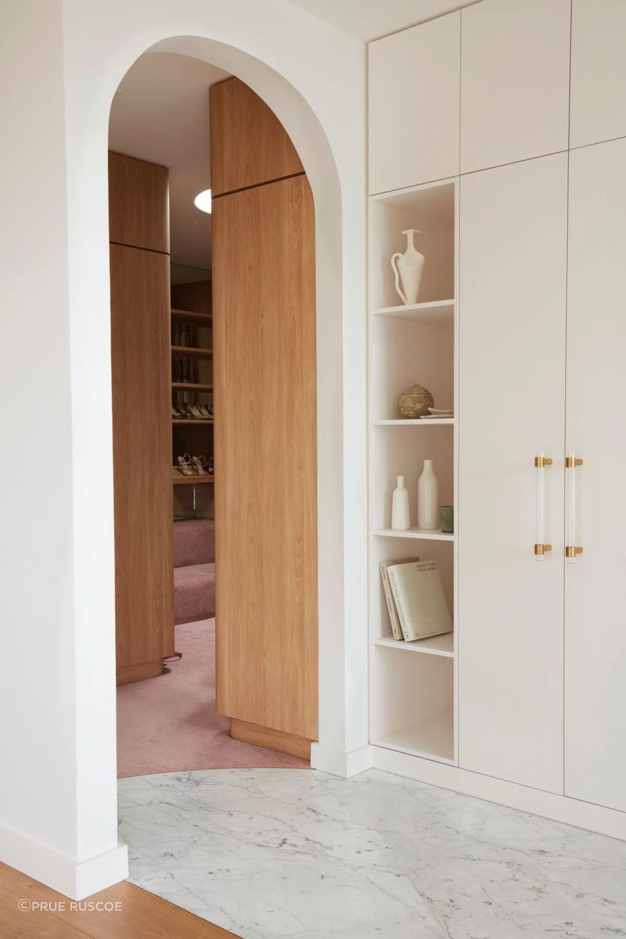 Pastel pink continues into the walk-in-wardrobe.
