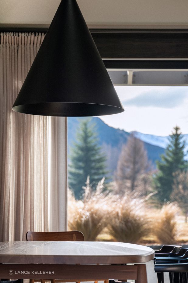 A stunning cone-shaped pendant light was chosen to subtly reflect the shapes of the mountains outside.