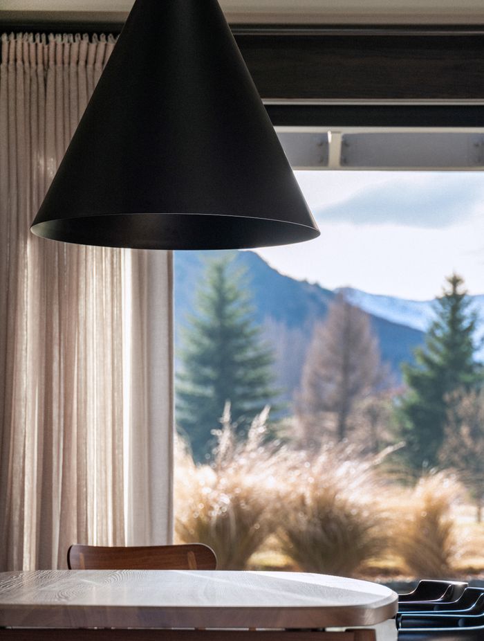 A stunning cone-shaped pendant light was chosen to subtly reflect the shapes of the mountains outside.