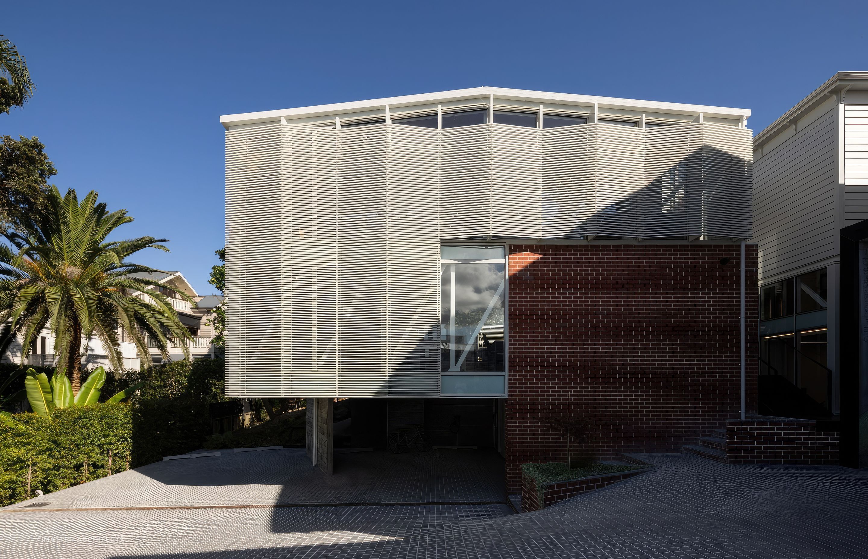 By carving into the earth beneath the original villa and constructing in-situ off-form concrete walls, Jonathan created a solid pedestal base for a three-level, cantilevered extension set a half-height below the villa.