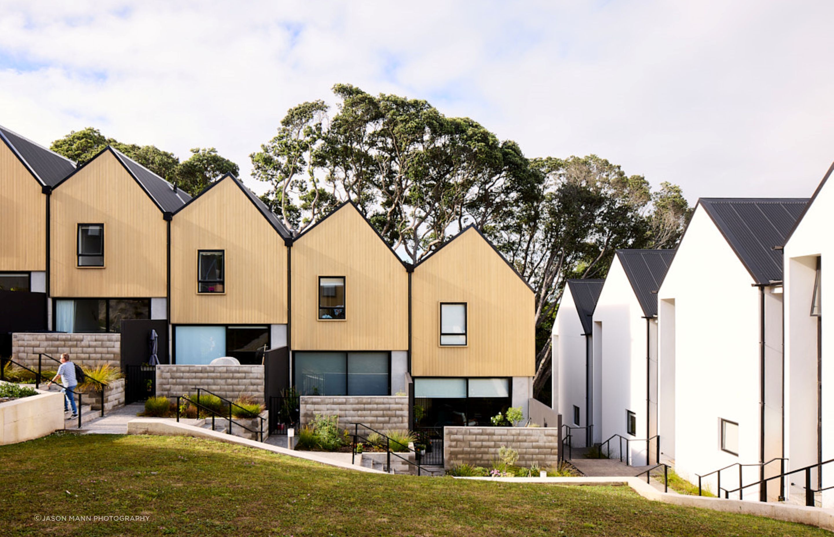 Terraced townhouses step down the site, and feature an asymmetrical roof pitch.