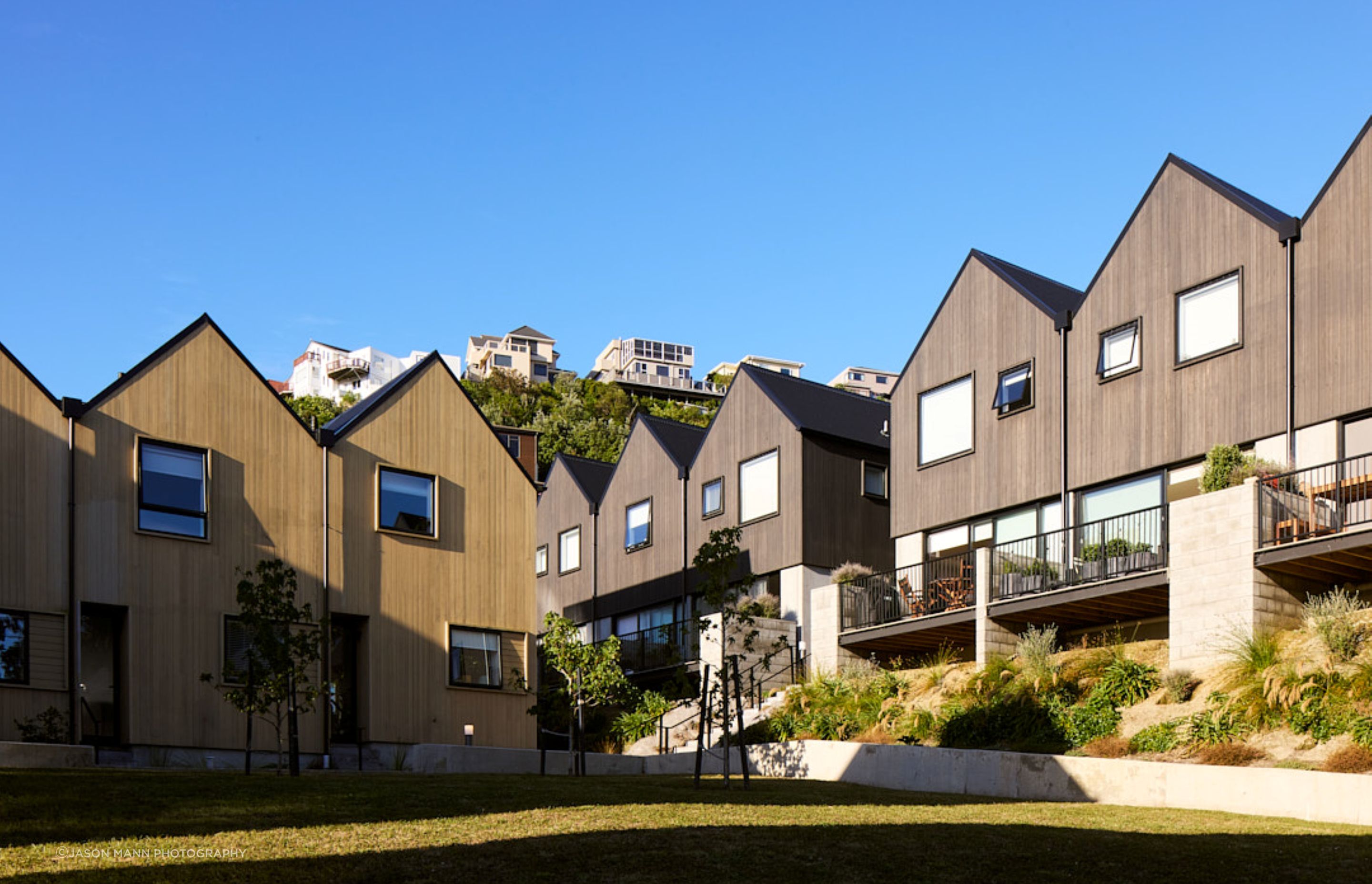 Contrasting timber and plaster exterior gives each building type its own identity.