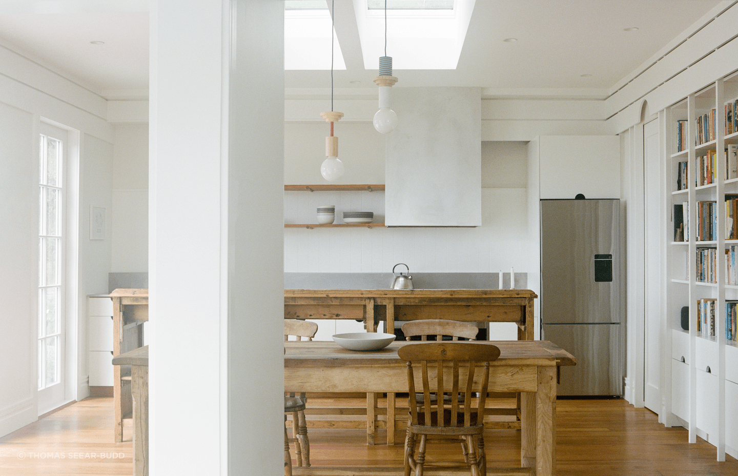 The new kitchen is flooded with lights and connects with the harbour views.