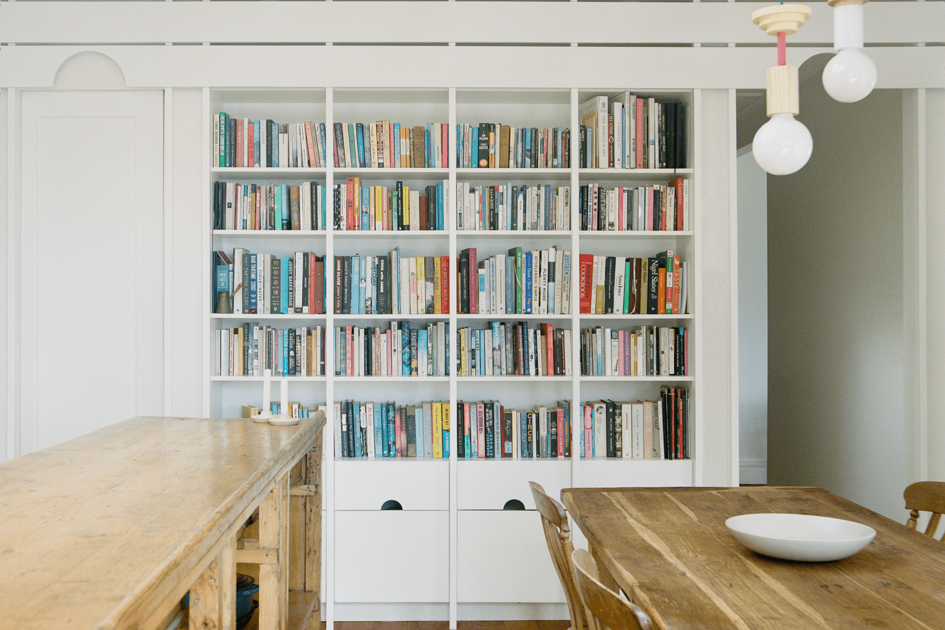 The repeated semicircle cut-out features on the built-in bookshelf.