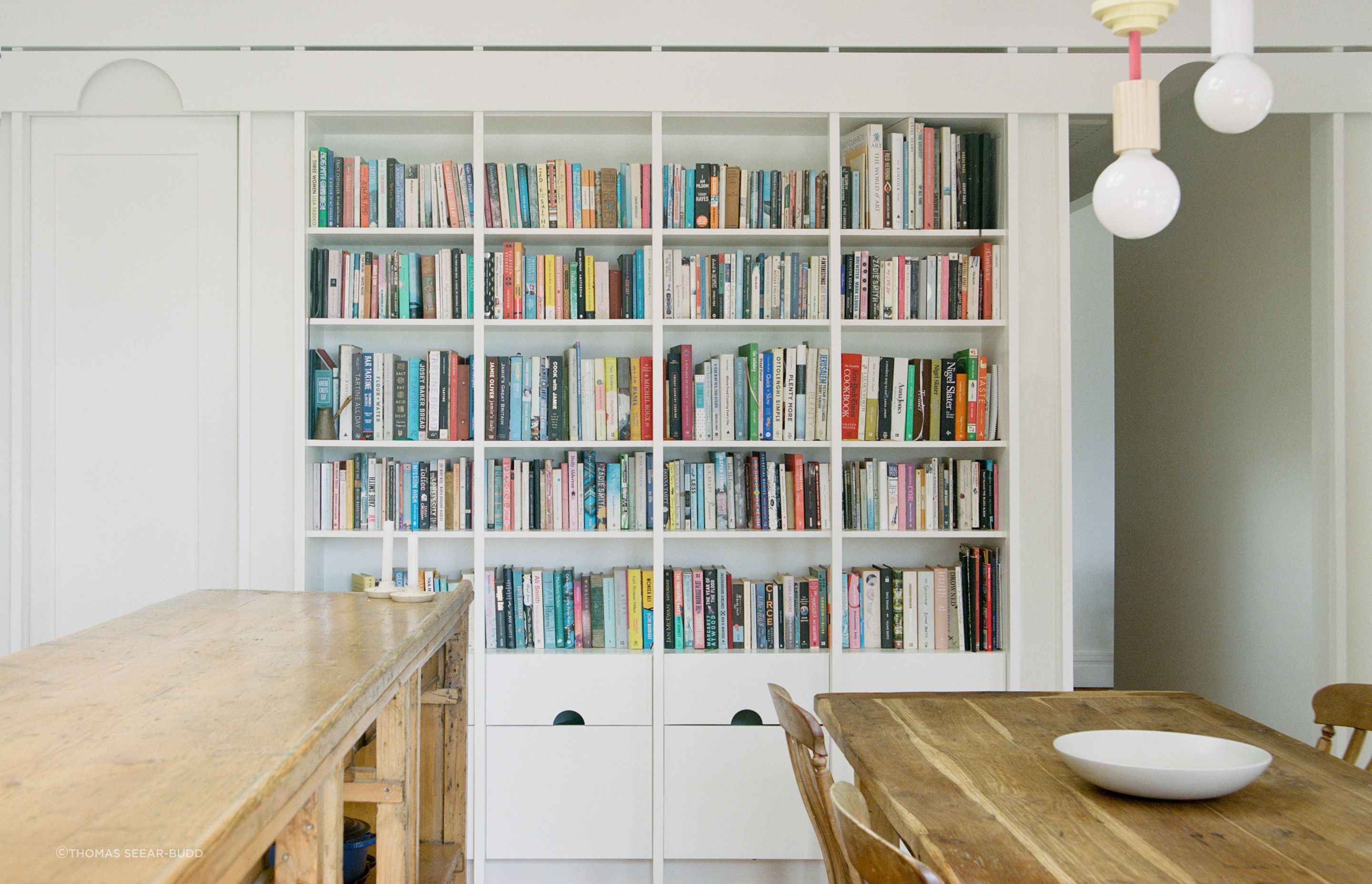 The repeated semicircle cut-out features on the built-in bookshelf.