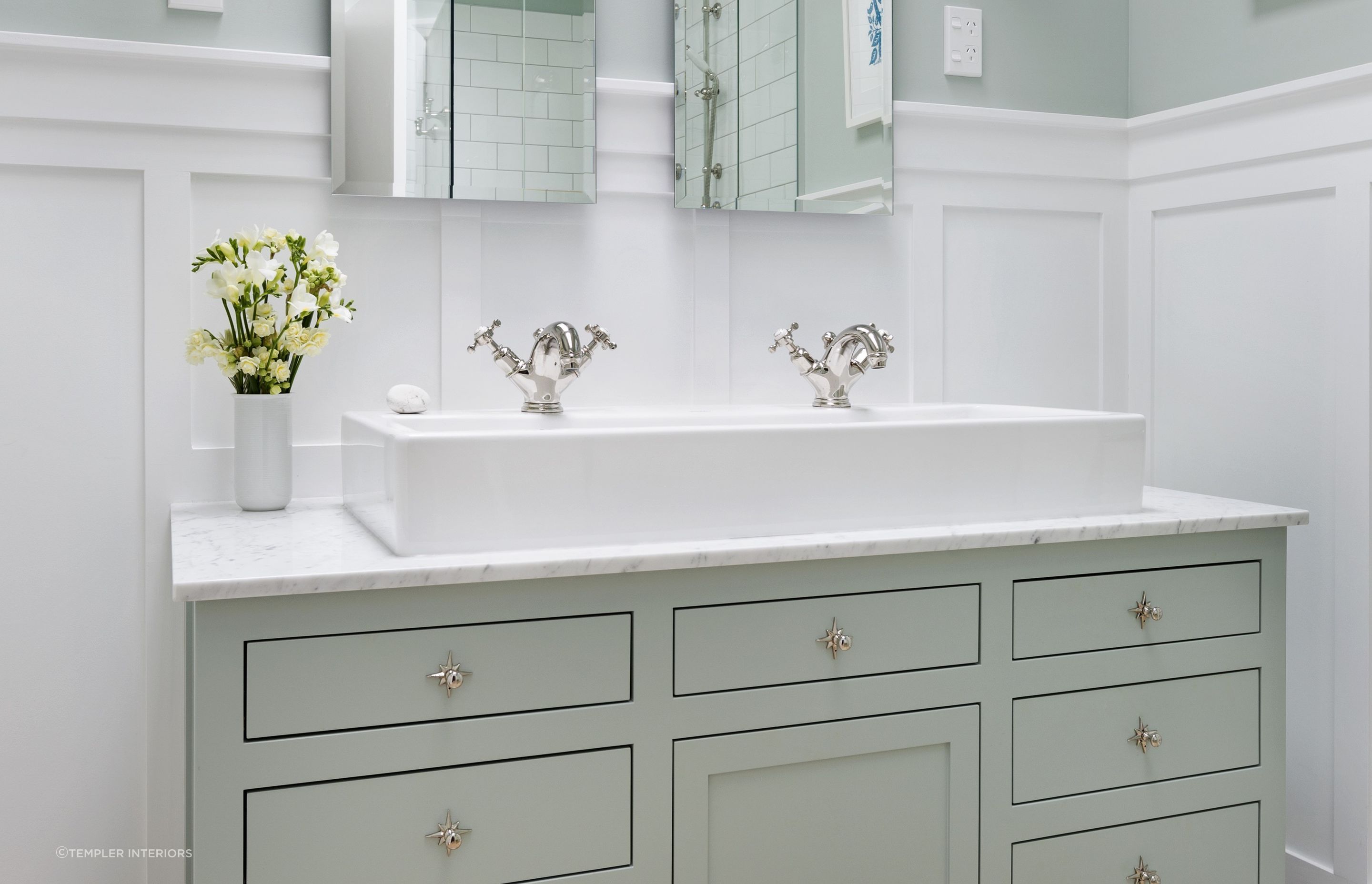 White wainscoting supported by superb furnishings gives a clean and polished look as seen in this Mt Eden villa renovation.