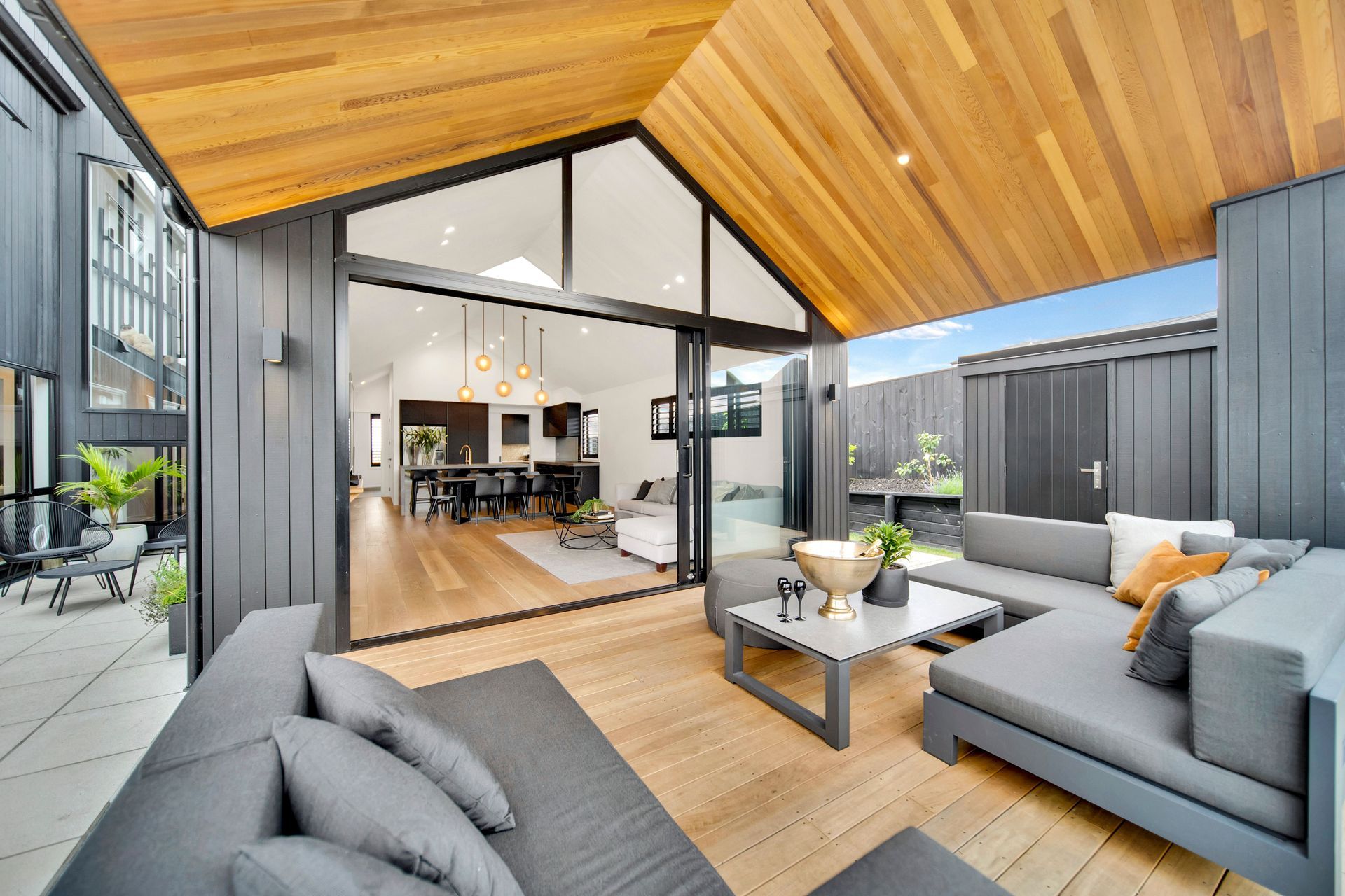 Natural cedar contrasts with the surrounding dark exterior.