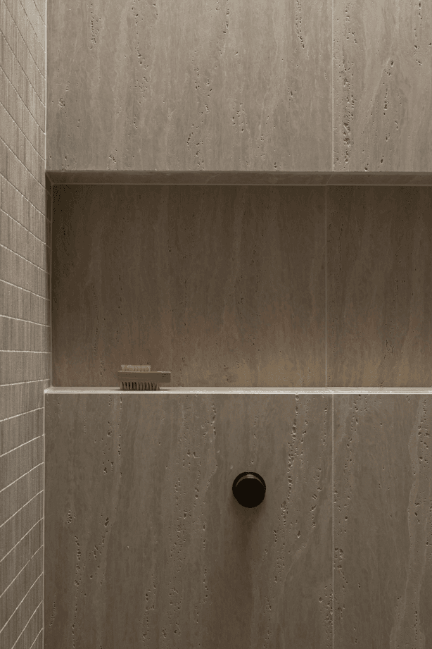 Beautiful and textural, the neutral tiles add sophistication to the small space.