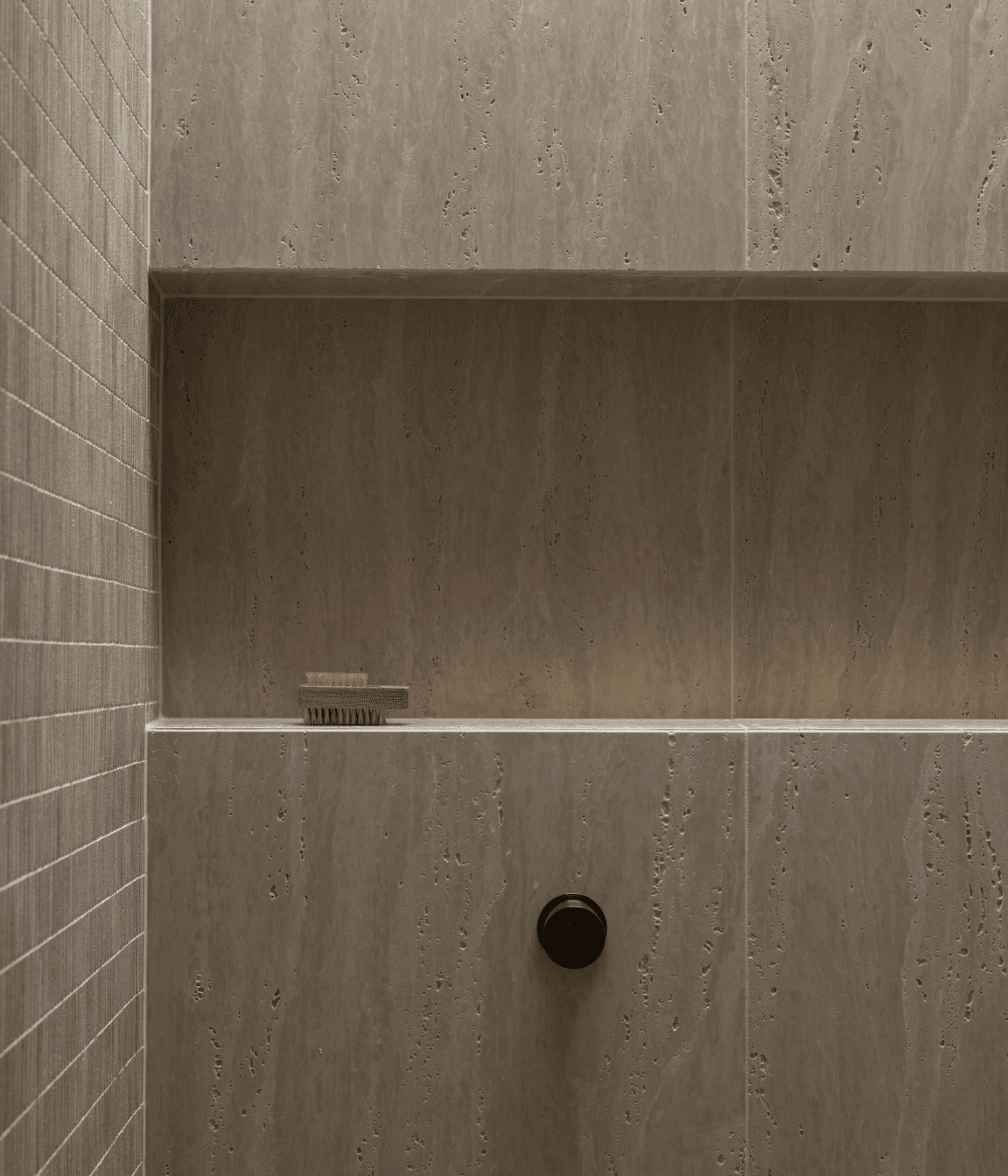 Beautiful and textural, the neutral tiles add sophistication to the small space.