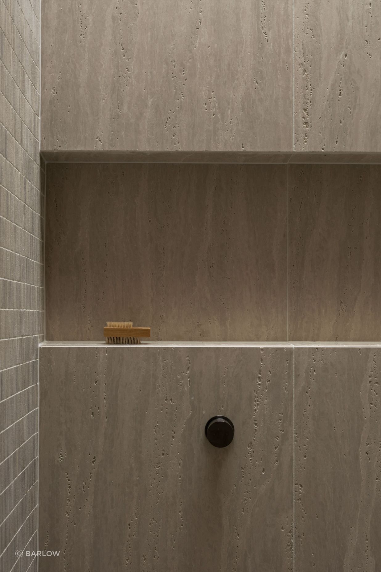 Beautiful and textural, the neutral tiles add sophistication to the small space.