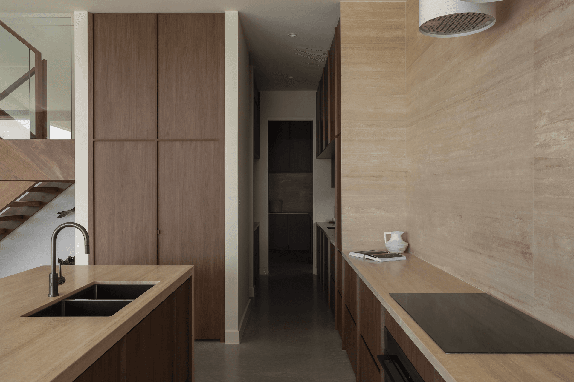 Chocolate-coloured timber cabinetry brings warmth to the kitchen, complete with a butler's pantry.