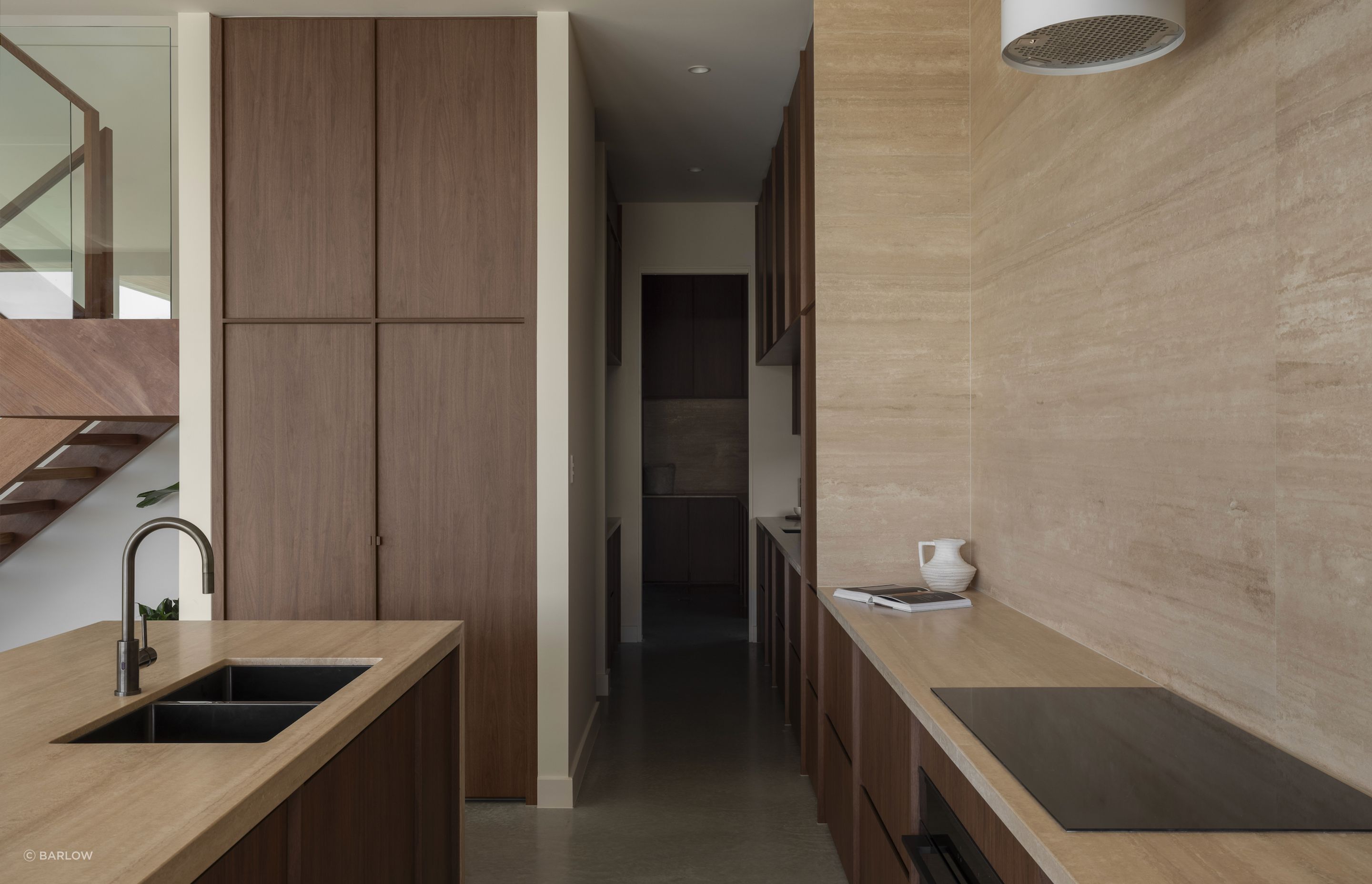 Chocolate-coloured timber cabinetry brings warmth to the kitchen, complete with a butler's pantry.