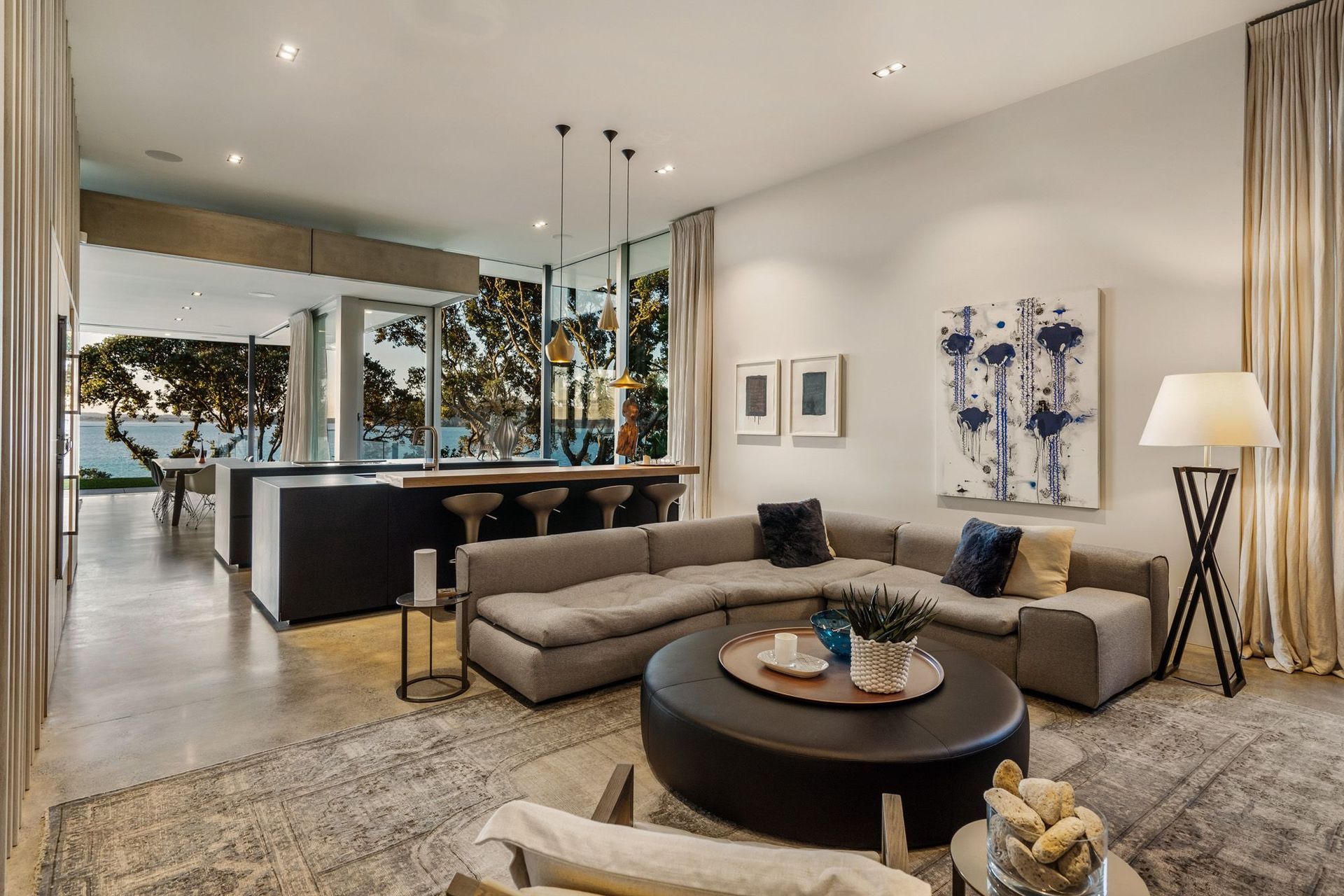 Within the kitchen area is a cosy snug space with a feature fireplace built into one of the stone sea walls.