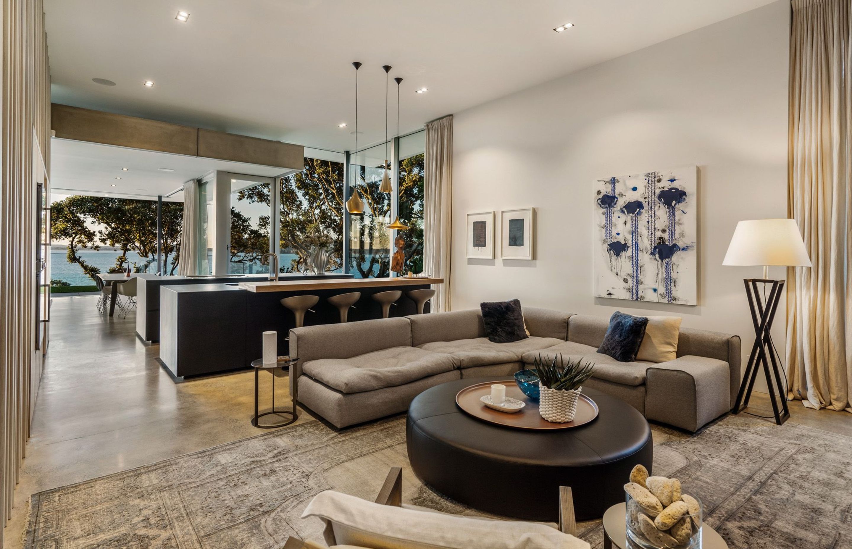 Within the kitchen area is a cosy snug space with a feature fireplace built into one of the stone sea walls.