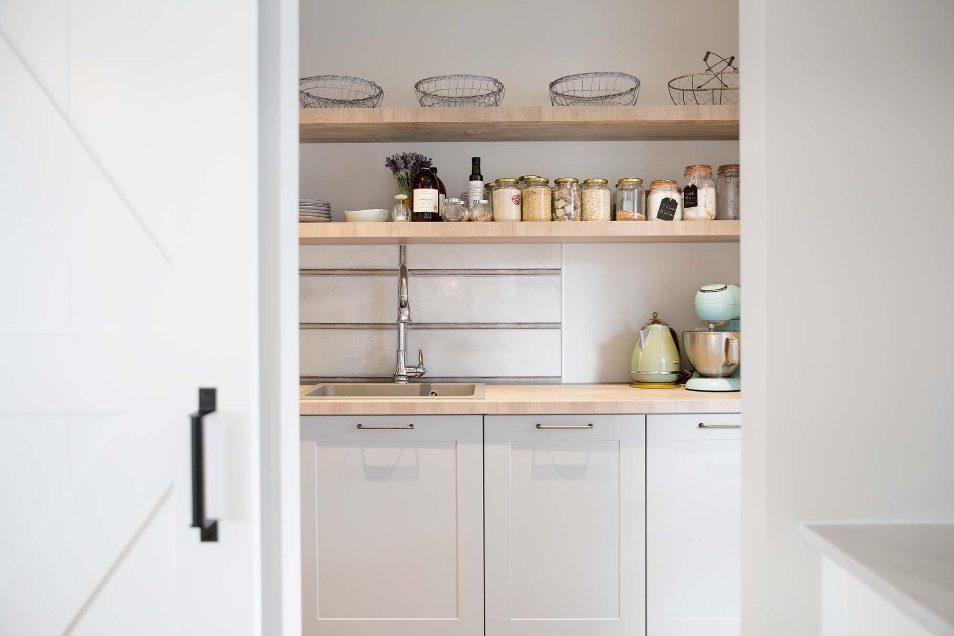 A stylish scullery with open shelving from Hacker Kitchens.