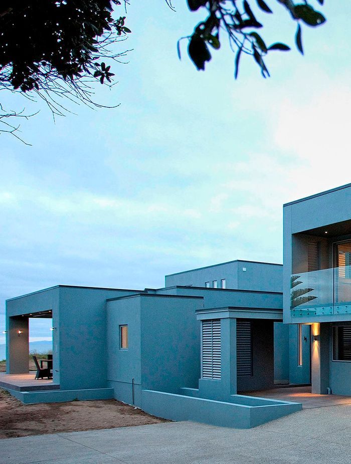 Soft eggshell blue blends this Orewa home into the sky and seascape.