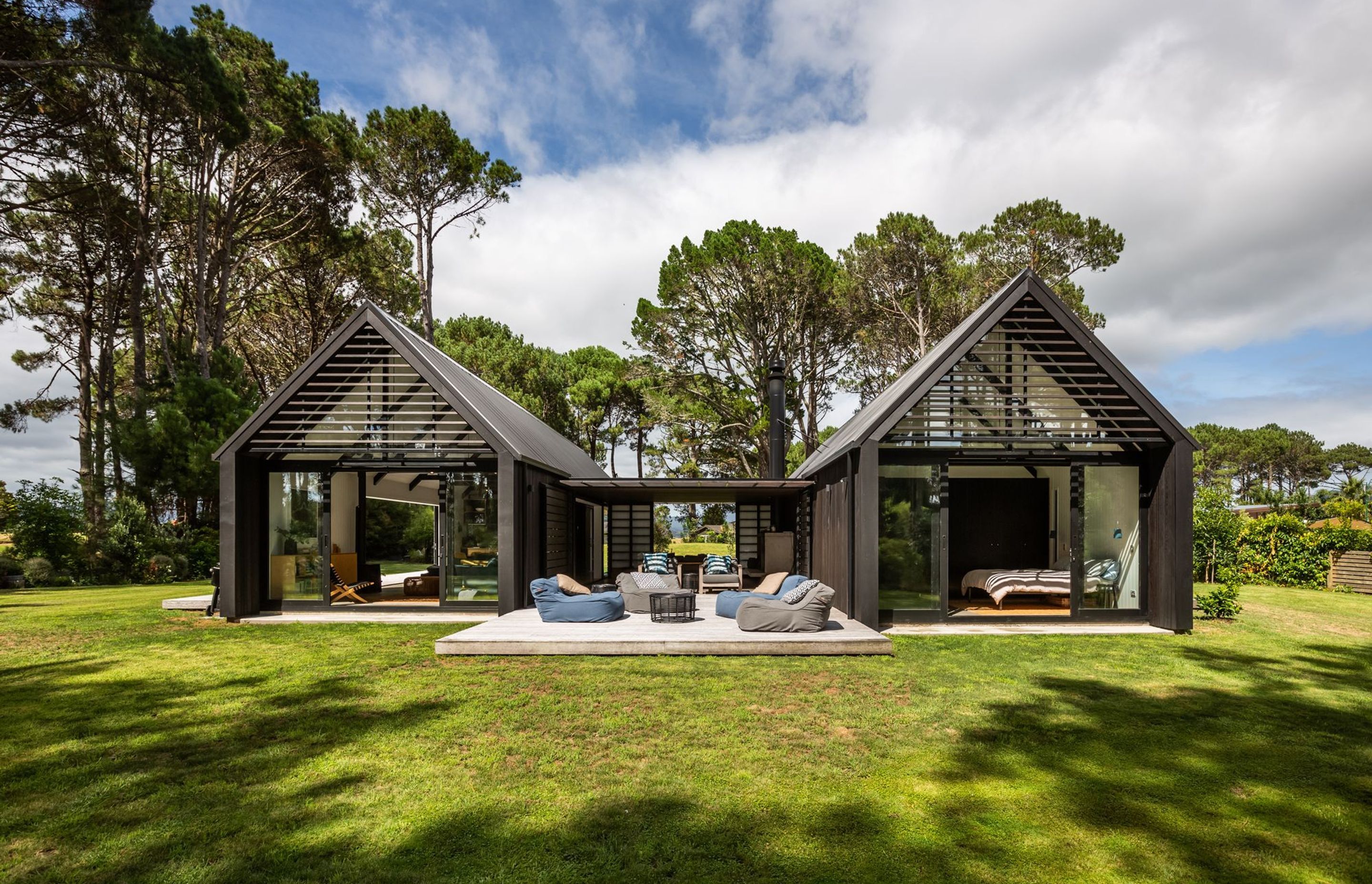 The two gabled forms are connected by a central linking building that houses a sheltered courtyard.