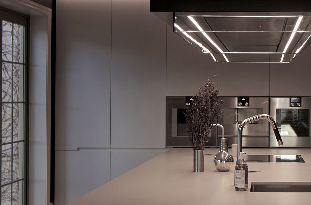 Bespoke lighting is a growing trend in kichens with this linear pendant light a key feature of this home in Havelock North, designed by Leanne Larking of quattro:uno.