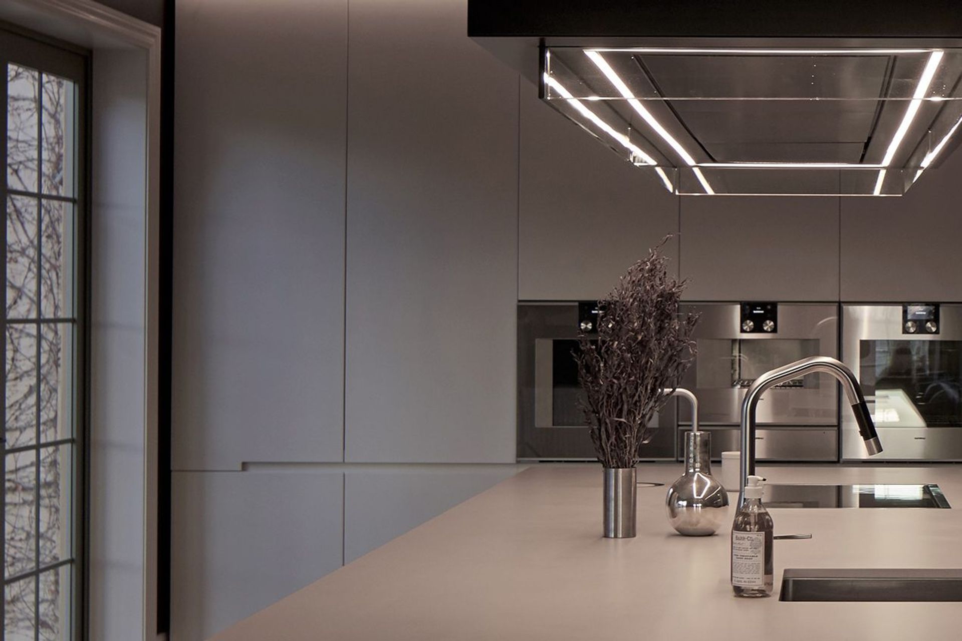 Bespoke lighting is a growing trend in kichens with this linear pendant light a key feature of this home in Havelock North, designed by Leanne Larking of quattro:uno.