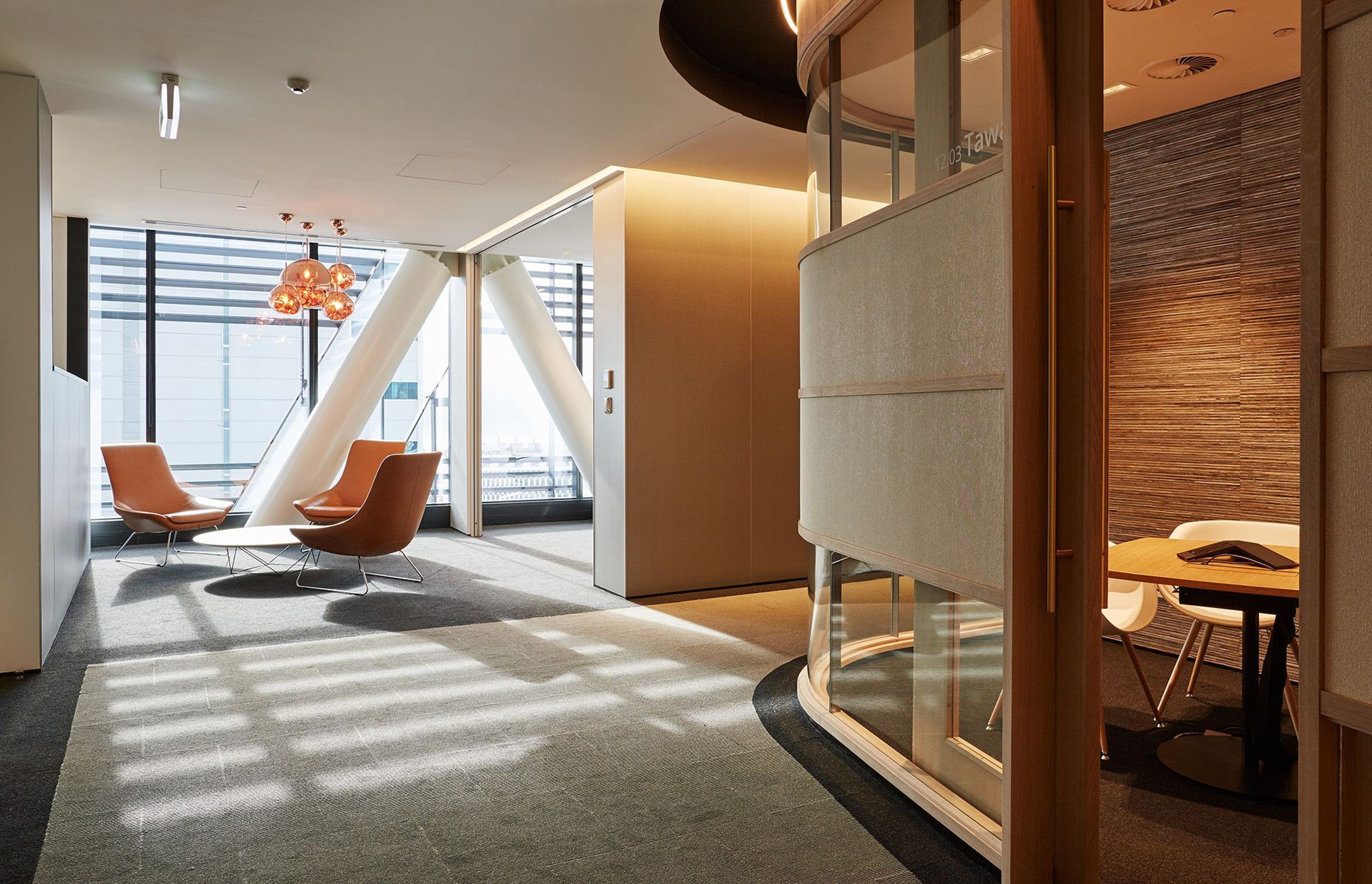 Intimate, light-filled nooks and crannies offer a sense of home in Deloitte's 12th floor office, seen above and above top.