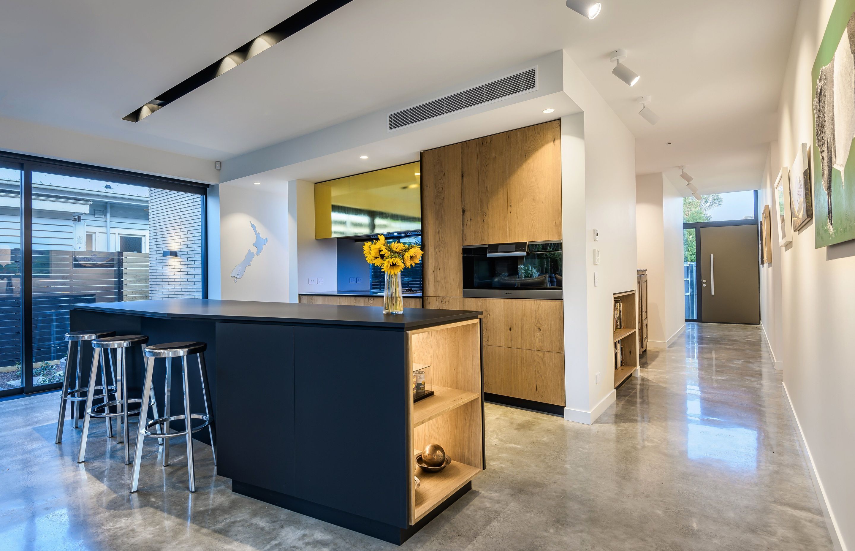 The functional kitchen island can work like a large stand-alone table with a decent overhang, so people can easily perch on the stools for breakfast, coffee or informal drinks