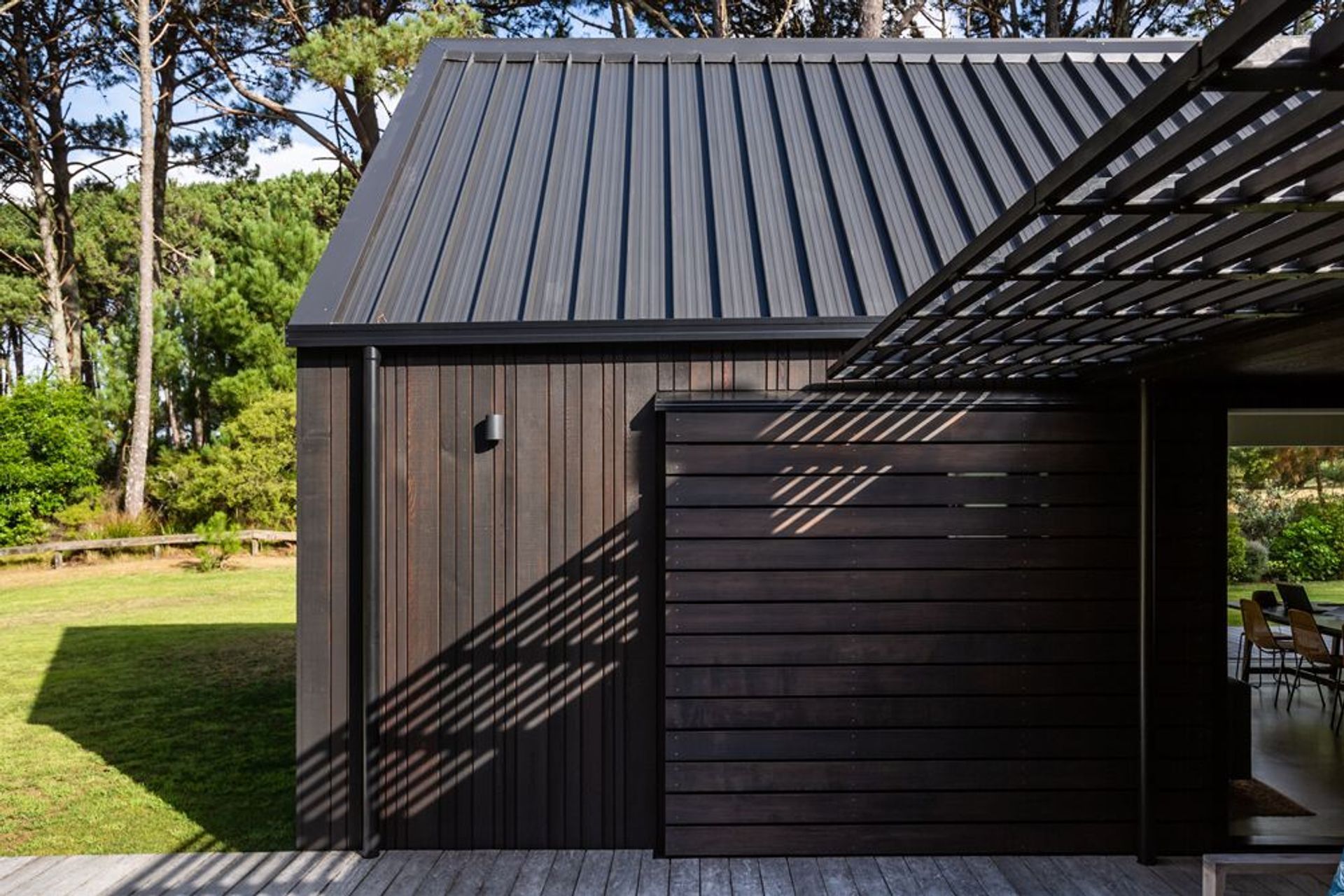 The 45-degree pitched roofs are a literal response to cabins in the woods. They are very clipped; there are no eaves yet the materials create a refined feel.