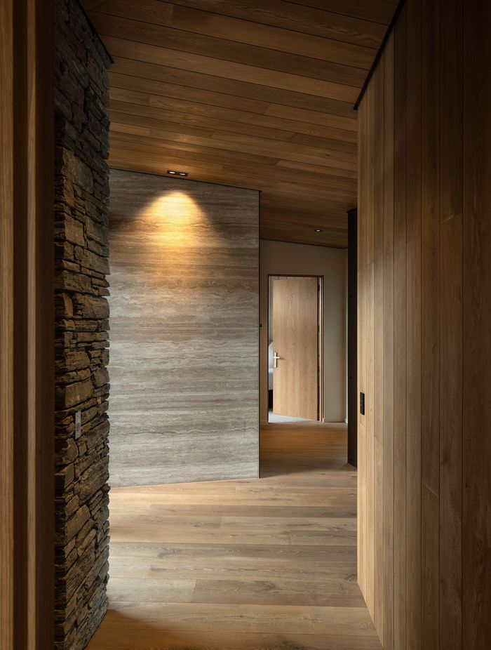 The hallway features oak, schist and travertine.