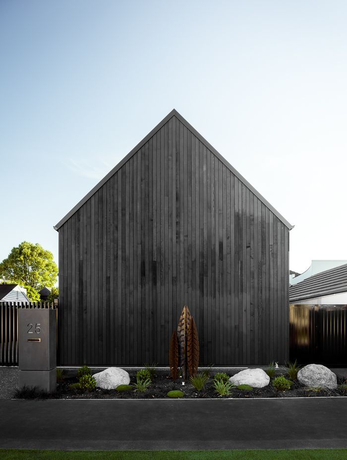 Outerspace used sub-tropical plants to soften this dramatic black cedar-cladding.