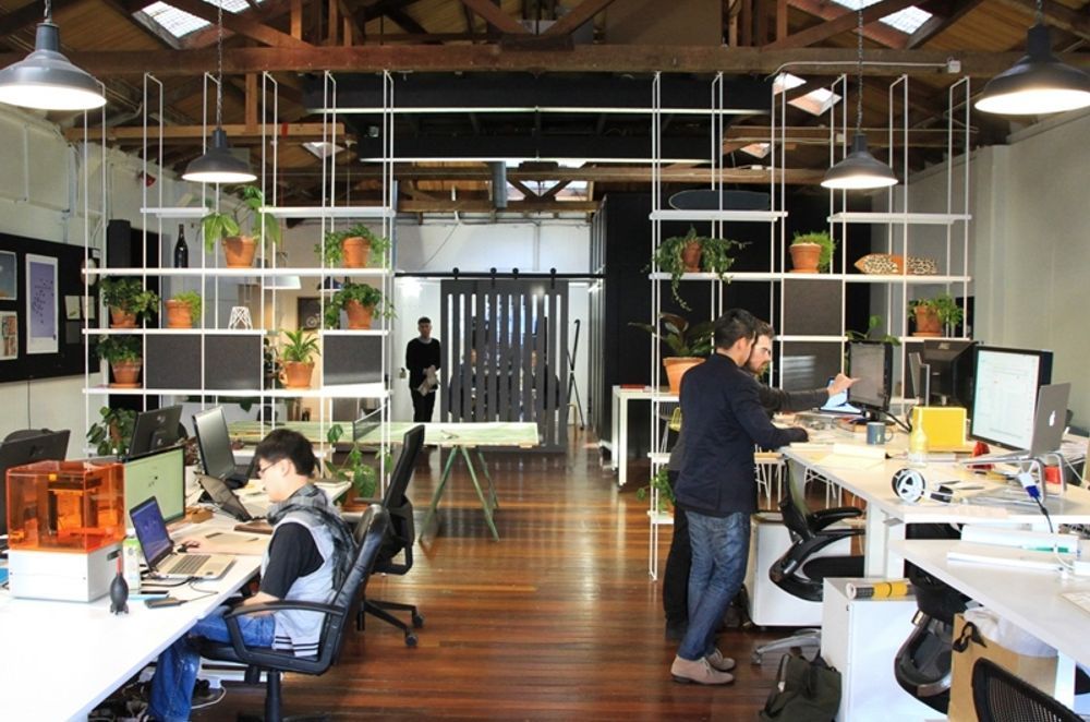 The open plan office for Think and Shift design studio uses panels and squares of acoustic materials to manage sound.