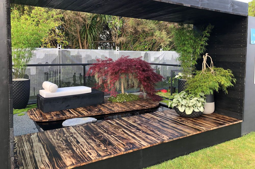 This urban oasis by Industry Landscapes has Asian-inspired elements bring a Zen-like influence to the space.. An ancient Japanese wood preservation technique is applied to multiple surfaces to create textural beauty.