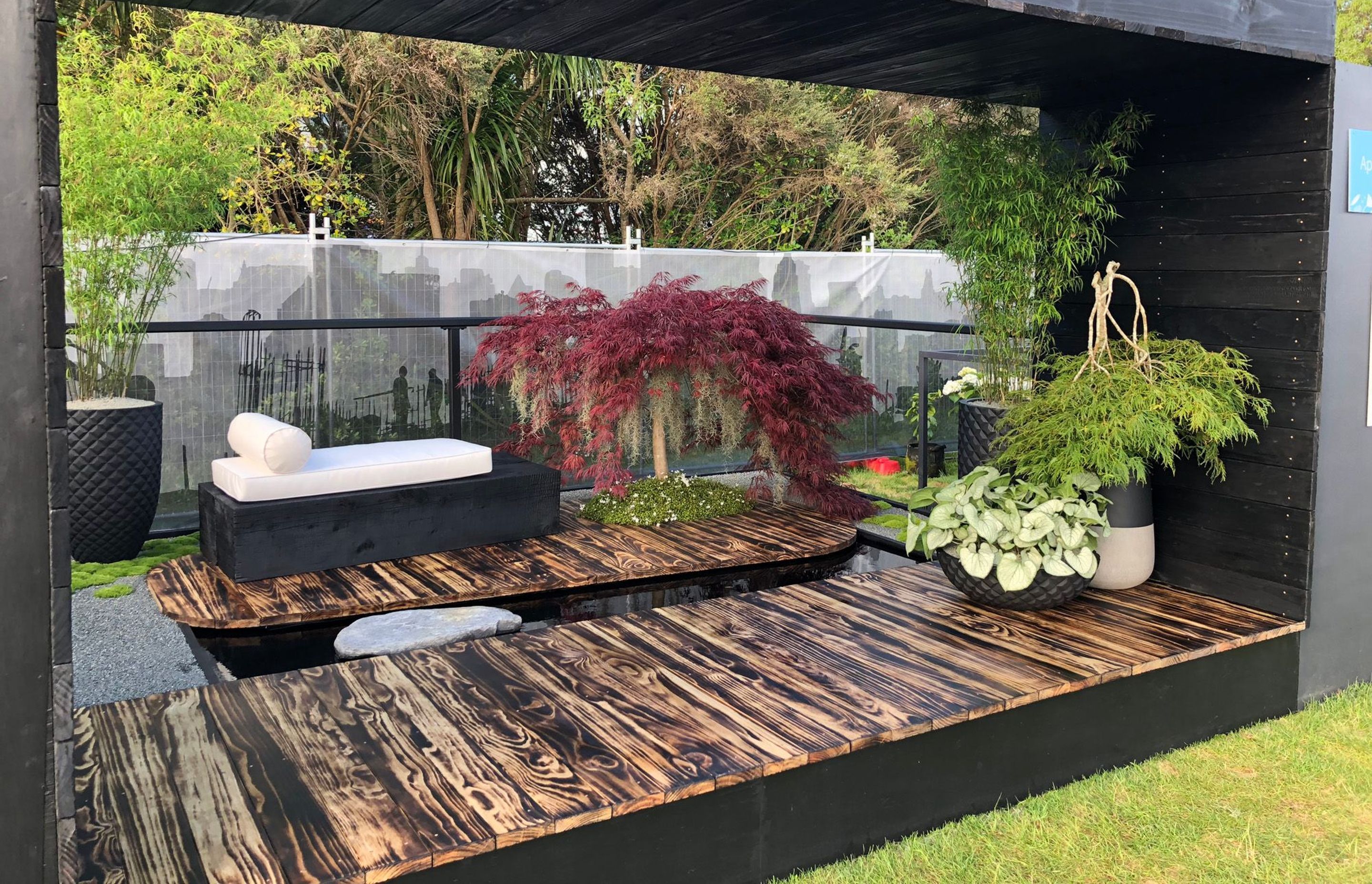 This urban oasis by Industry Landscapes has Asian-inspired elements bring a Zen-like influence to the space.. An ancient Japanese wood preservation technique is applied to multiple surfaces to create textural beauty.