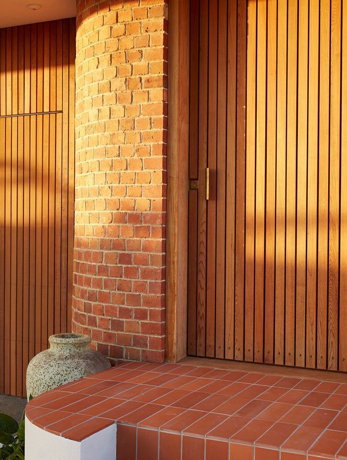 A new entrance punctuates the curved brick of the recently renovated, post-deco Owairaka House, Auckland, by Raukura Turei.