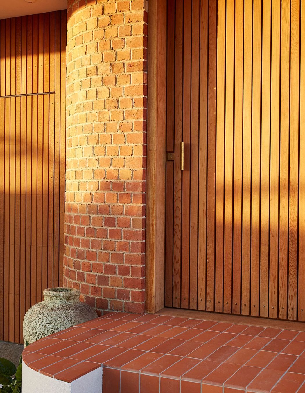 A new entrance punctuates the curved brick of the recently renovated, post-deco Owairaka House, Auckland, by Raukura Turei.