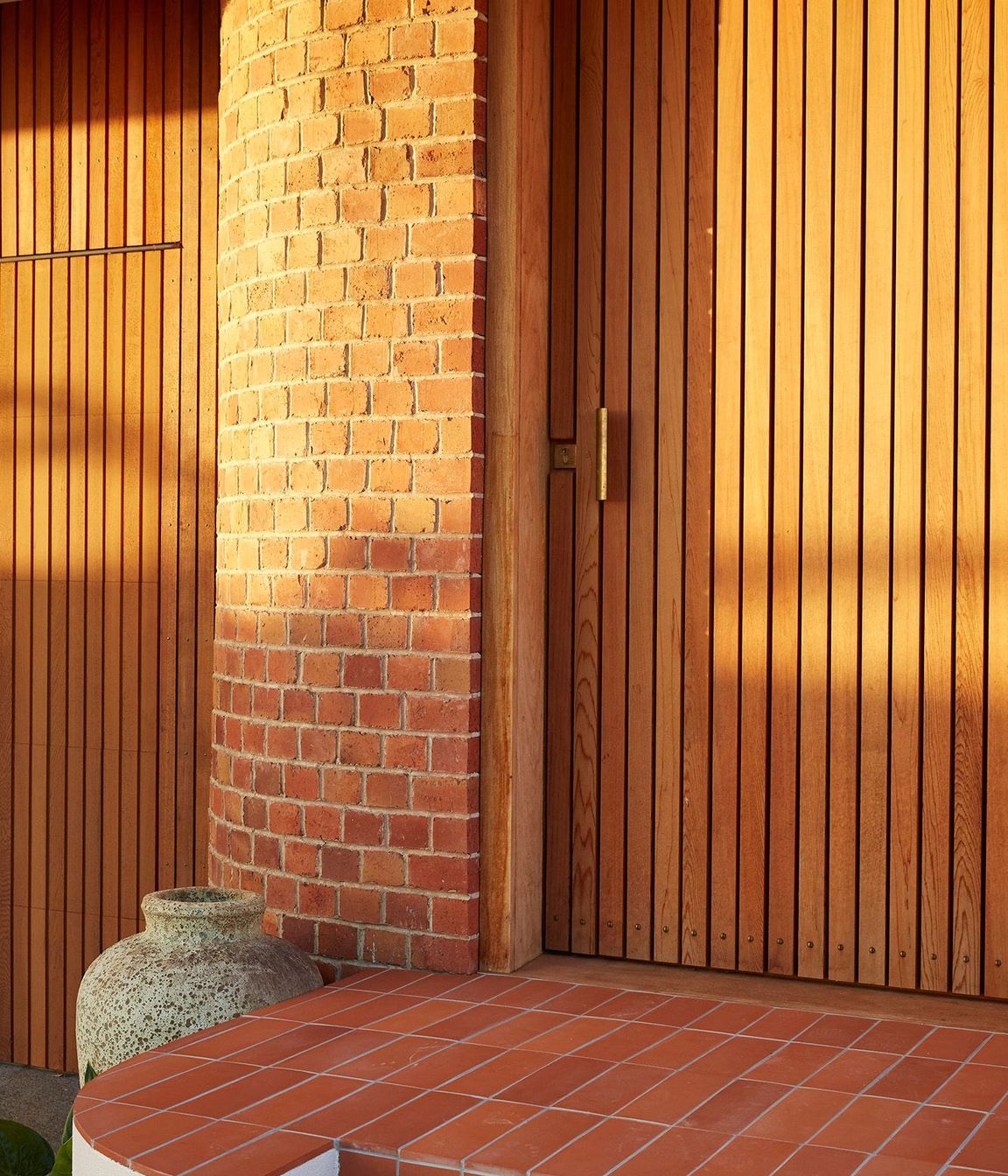 A new entrance punctuates the curved brick of the recently renovated, post-deco Owairaka House, Auckland, by Raukura Turei.