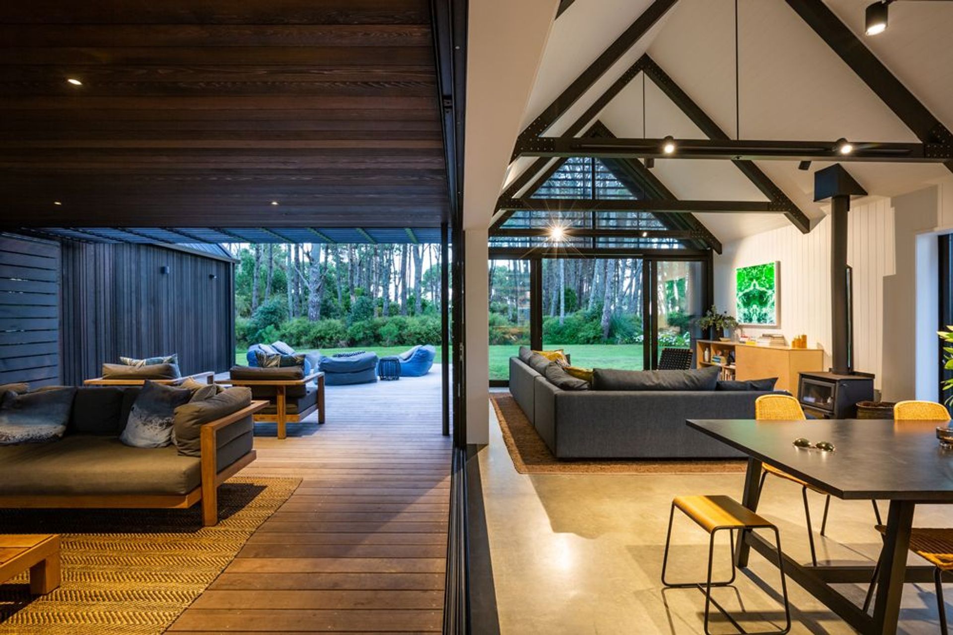 When you step out onto the central Vitex deck, the lighter cedar ceiling of the enclosed area acts as a link between the raw, robust interior palette and the dark-stained cedar of the exterior.