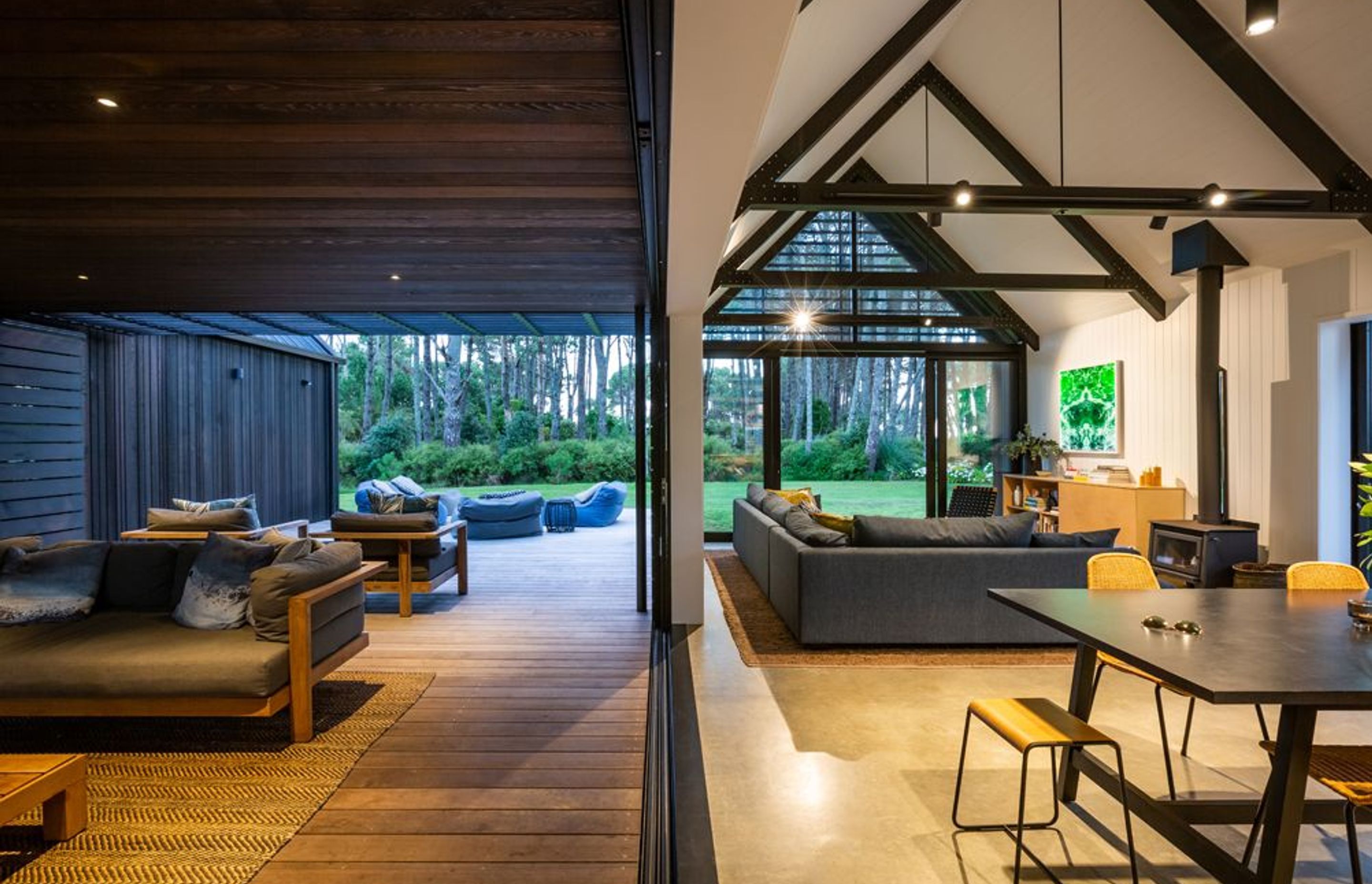 When you step out onto the central Vitex deck, the lighter cedar ceiling of the enclosed area acts as a link between the raw, robust interior palette and the dark-stained cedar of the exterior.