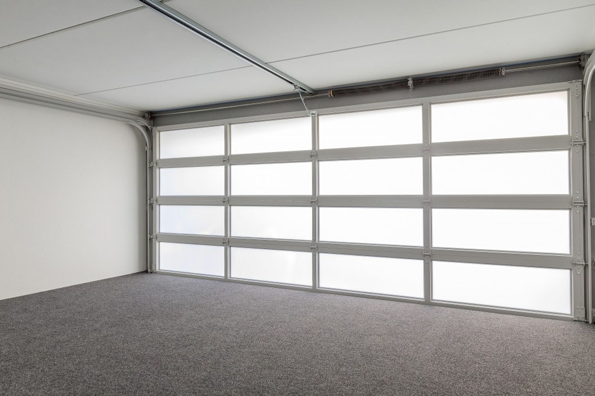Plexiglass garage doors not only look smart, they allow light into your garage and can be lit to dramatic effect