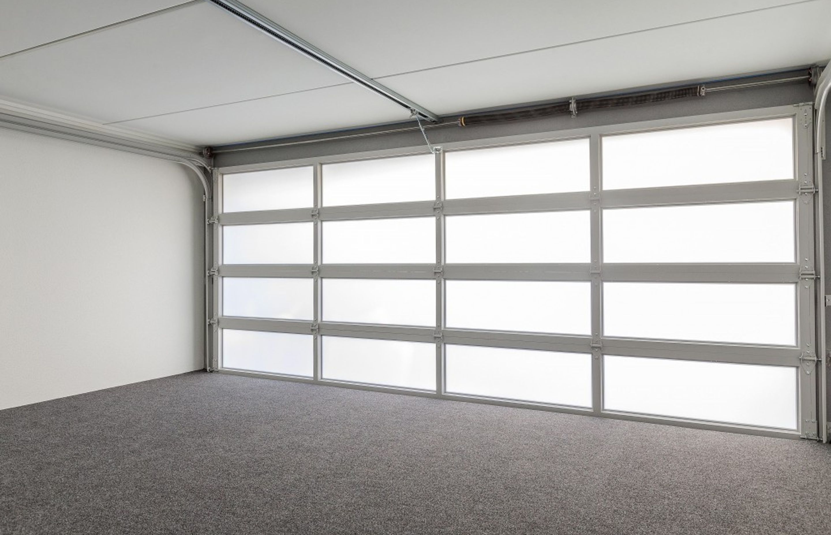 Plexiglass garage doors not only look smart, they allow light into your garage and can be lit to dramatic effect