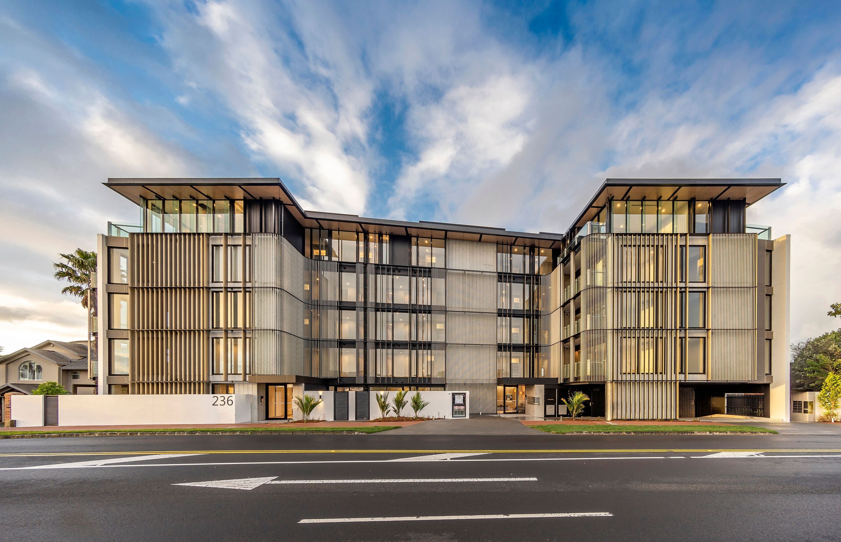The apartment complex comprises 33 apartments across five storeys in the main building, and a further 10 apartments in two separate two-storey buildings to the north of the site.