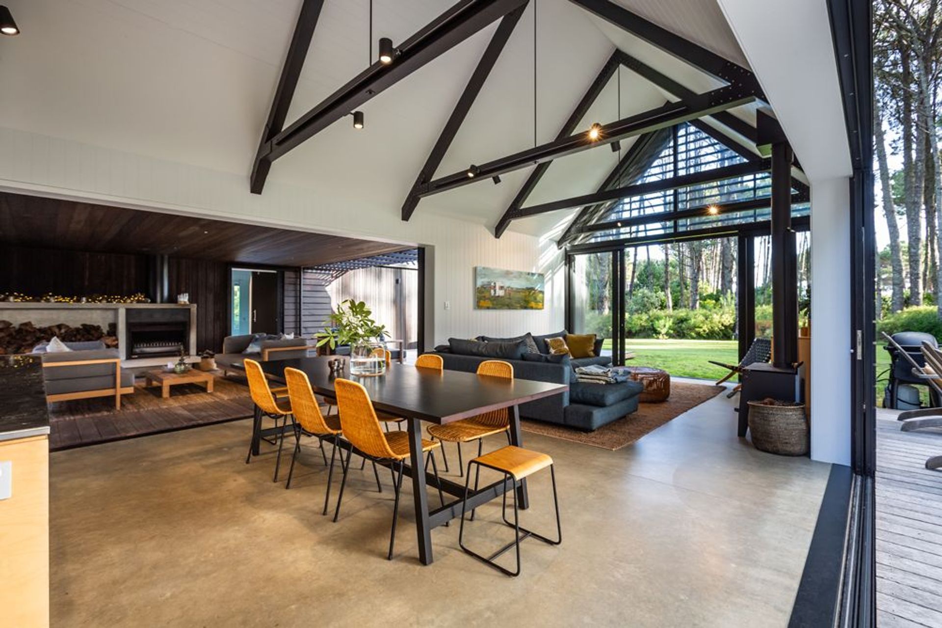 Exposed beams accentuate the gabled form, while a simple exposed concrete floor is combined with painted ply walls and ceilings.