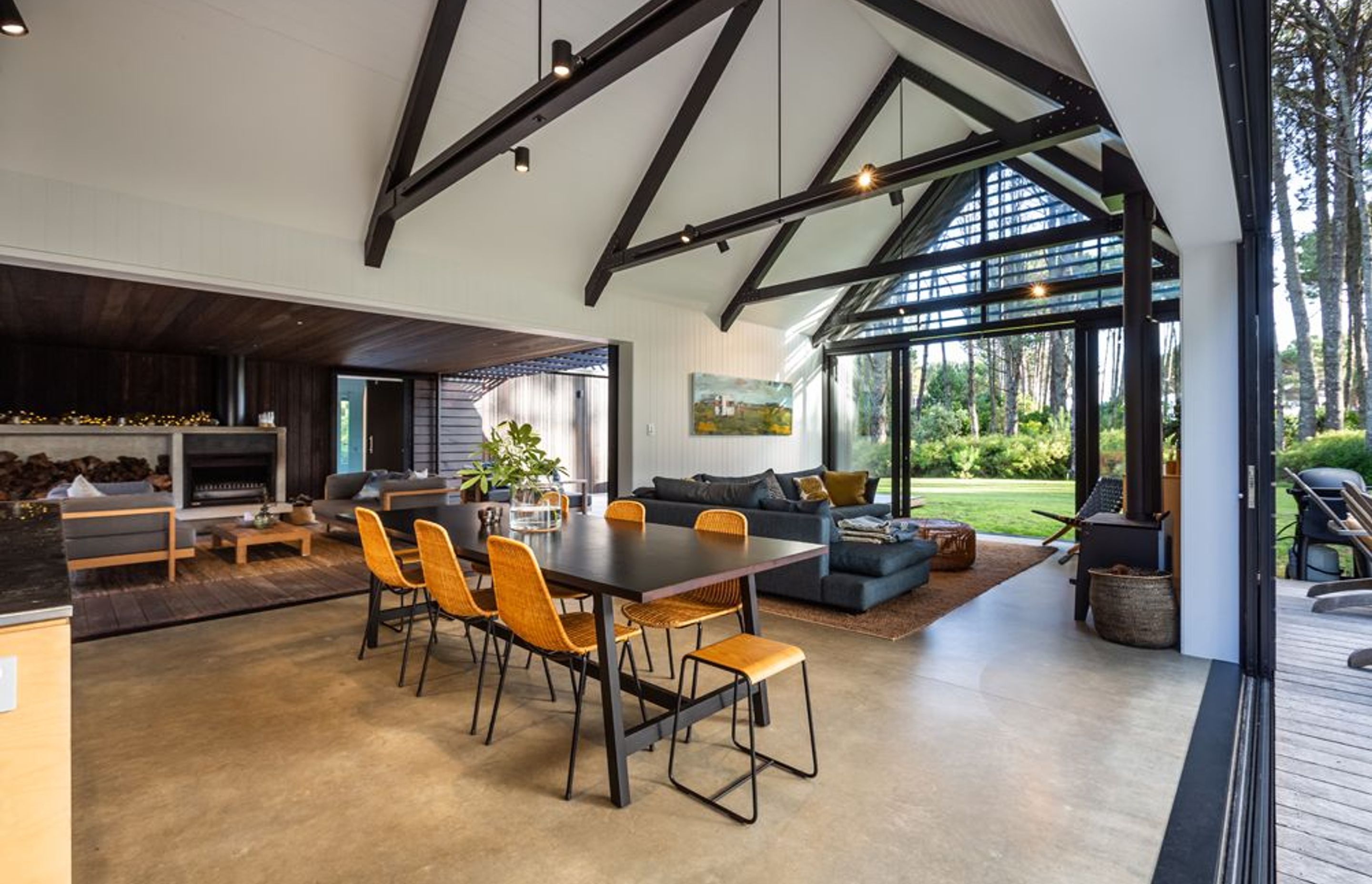 Exposed beams accentuate the gabled form, while a simple exposed concrete floor is combined with painted ply walls and ceilings.