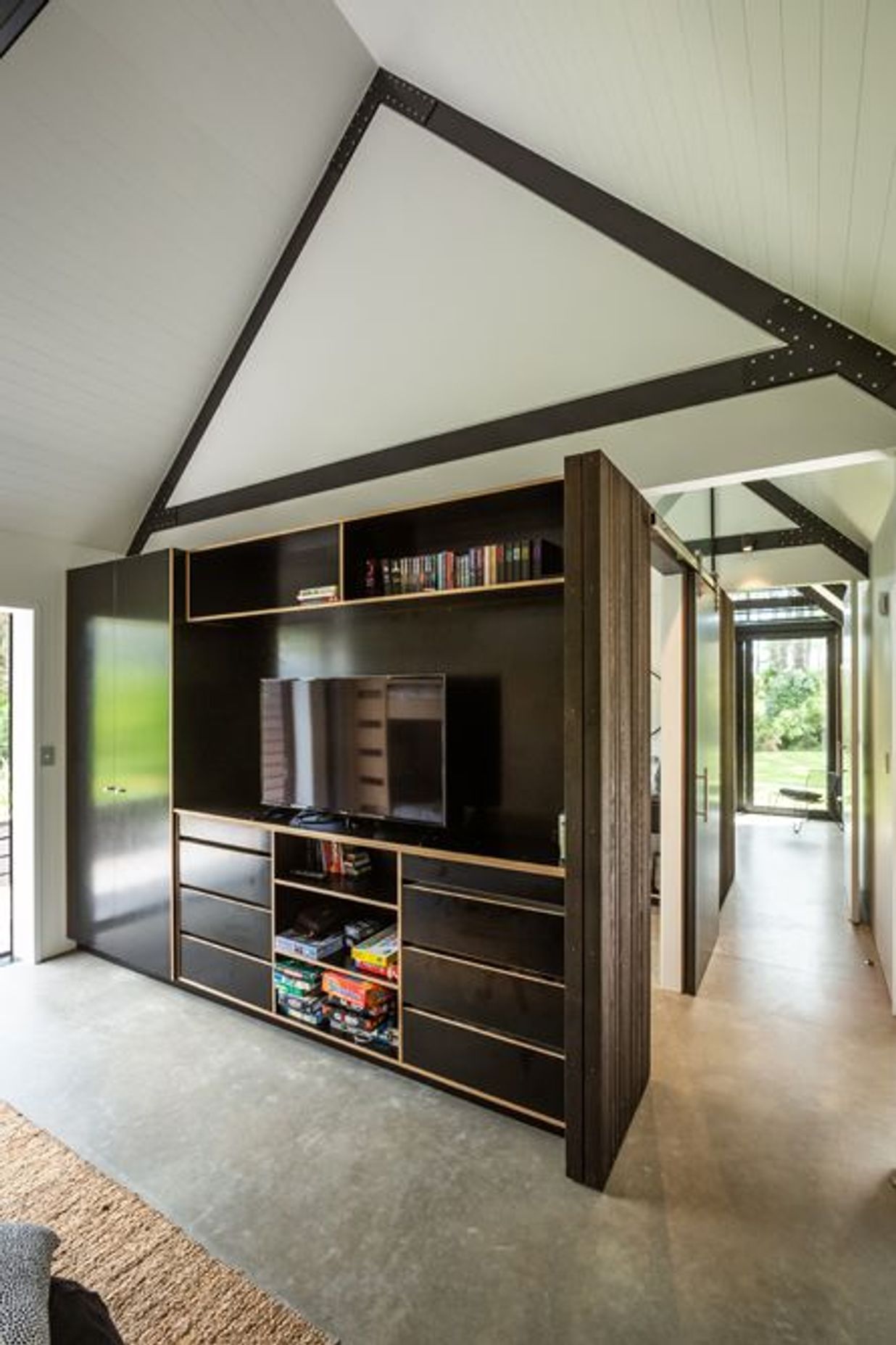 The exposed concrete floor creates a raw, relaxed aesthetic.