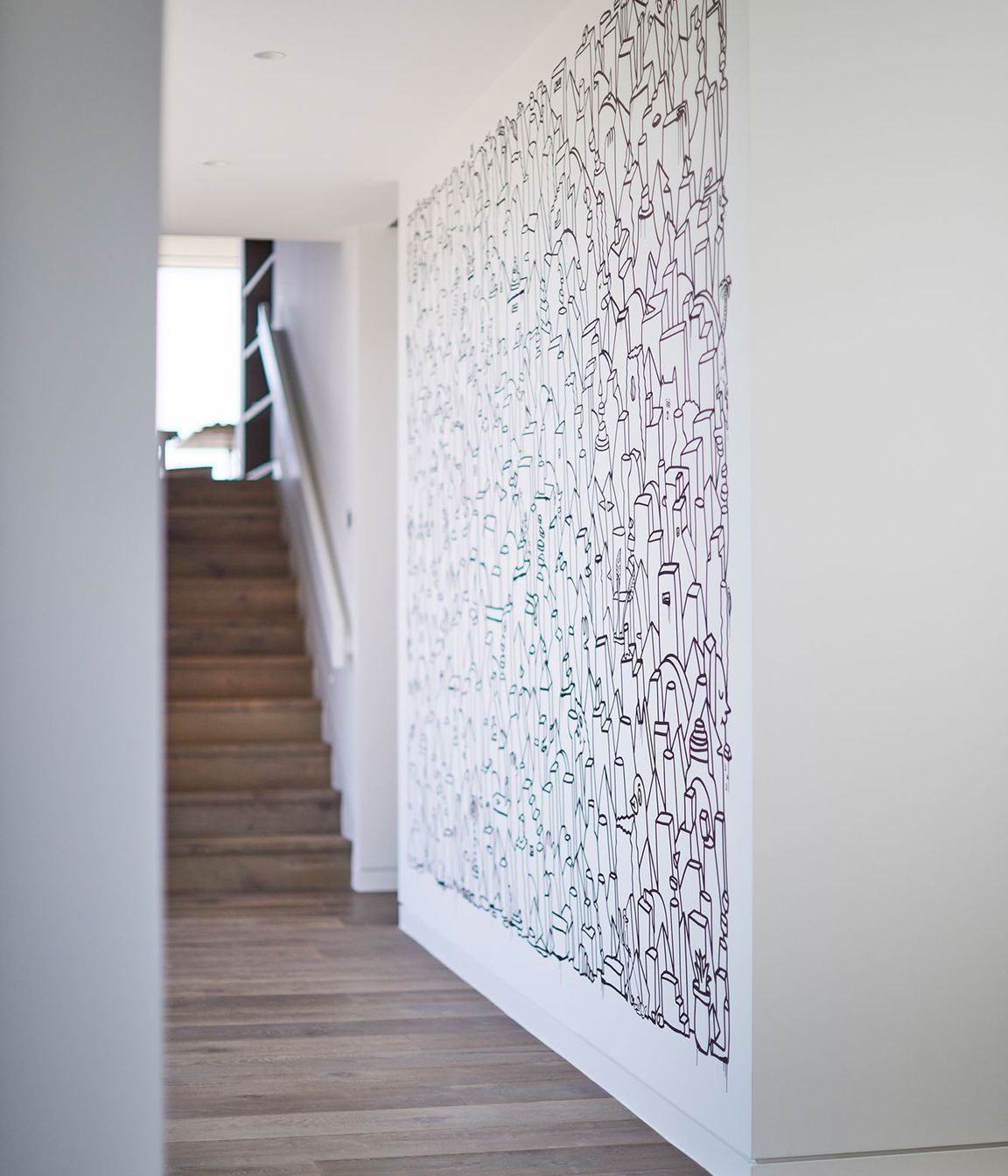 The informal entry into the house is on the second level, where stairs lead up to the main open plan living area.