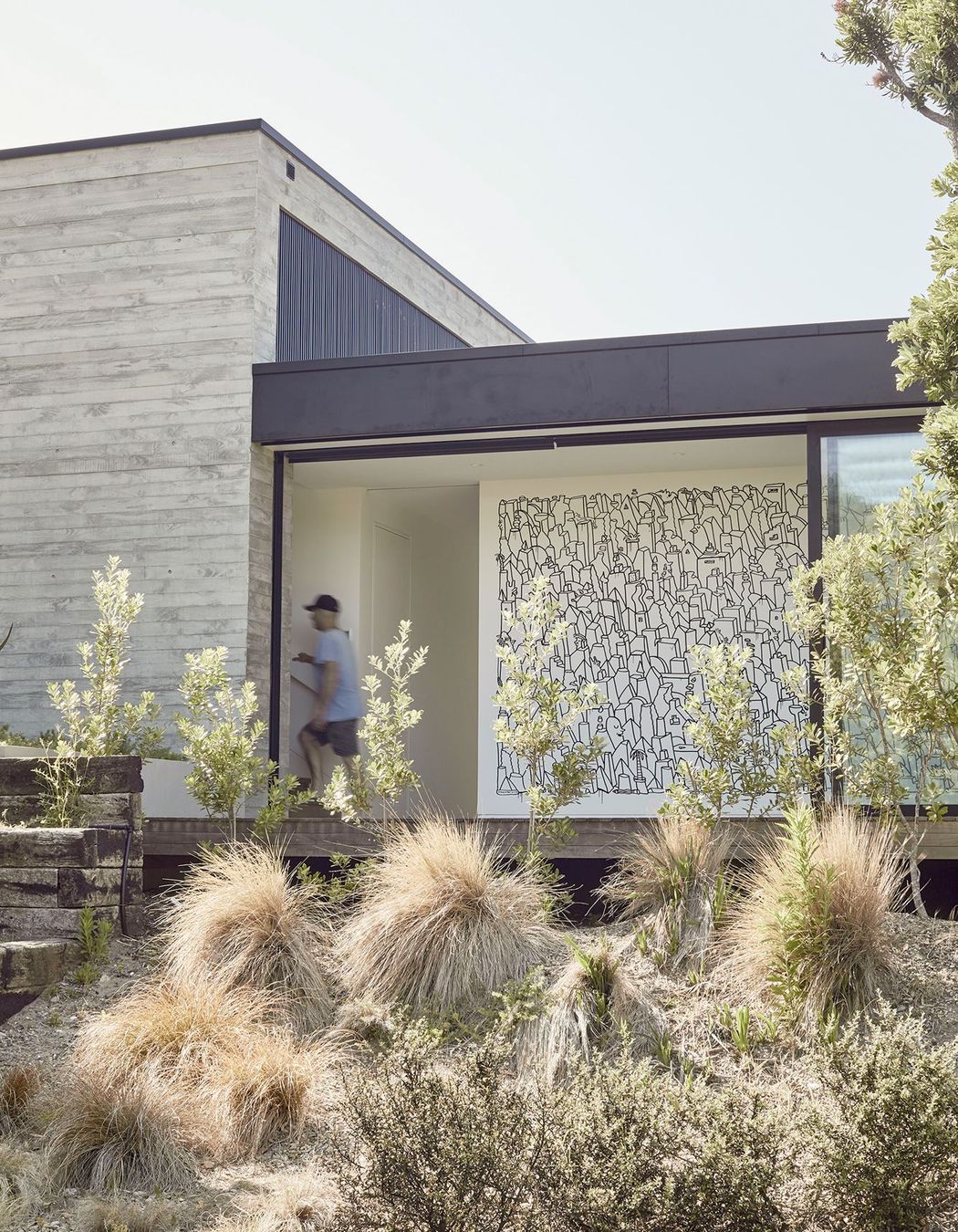 A large mural by artist Andrew J. Steel commissioned by the clients offers an insight into the intention of the spaces within. 