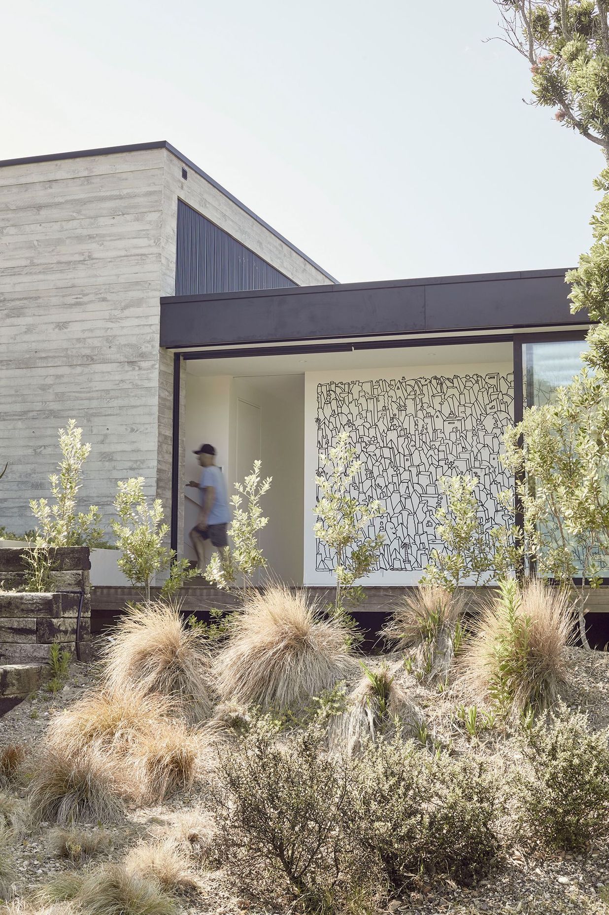 A large mural by artist Andrew J. Steel commissioned by the clients offers an insight into the intention of the spaces within.
