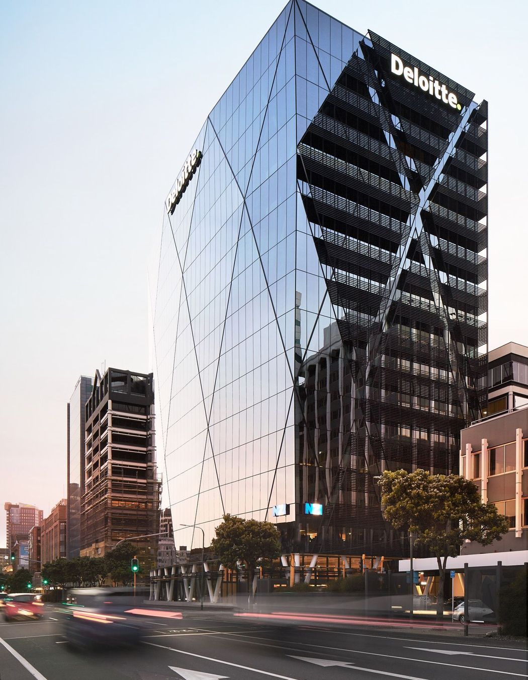 On the street edge, the glazing pulls back to expose the diagrid structure.